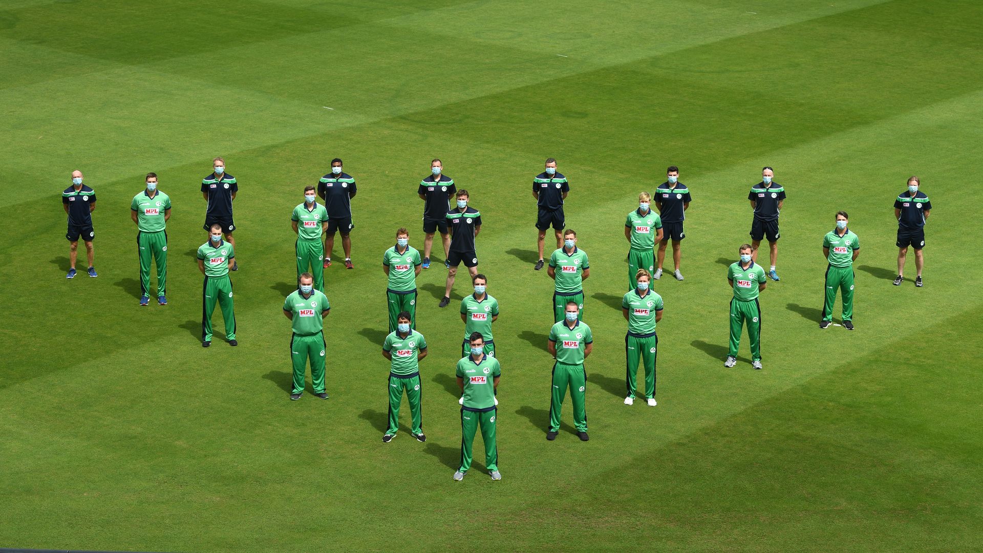 irish cricket players lined up for a socially-distanced team photo
