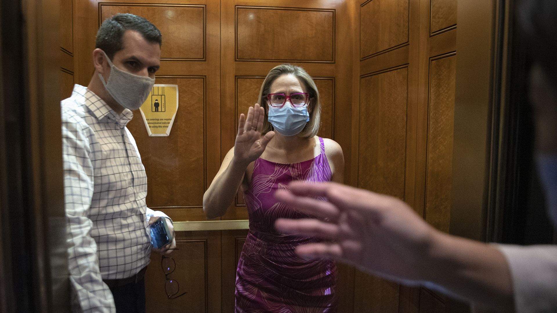 The notoriously press-shy Sen. Kyrsten Sinema is seen briefly speaking with reporters on Tuesday.