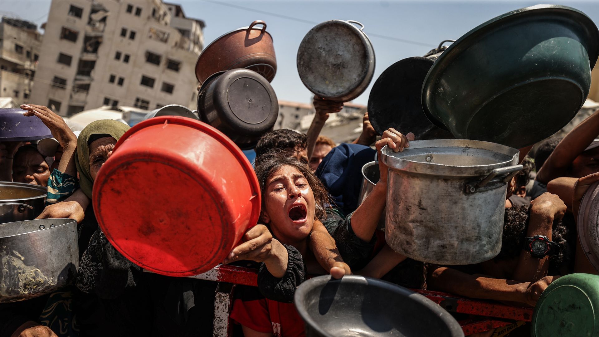 Palestinians ask for aid in Gaza City on July 28.