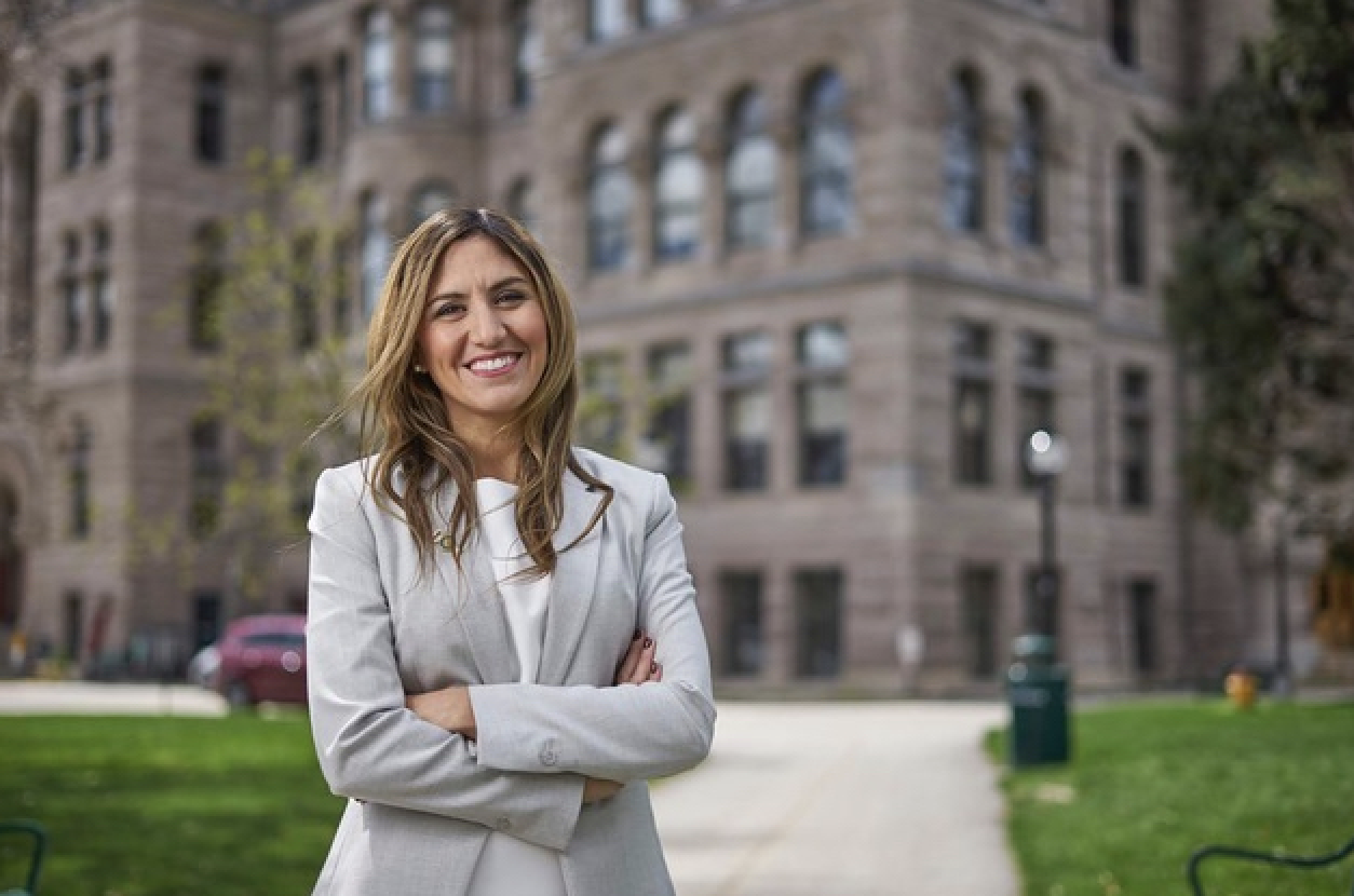 A woman standing in front of the Salt Lake City & County Building.