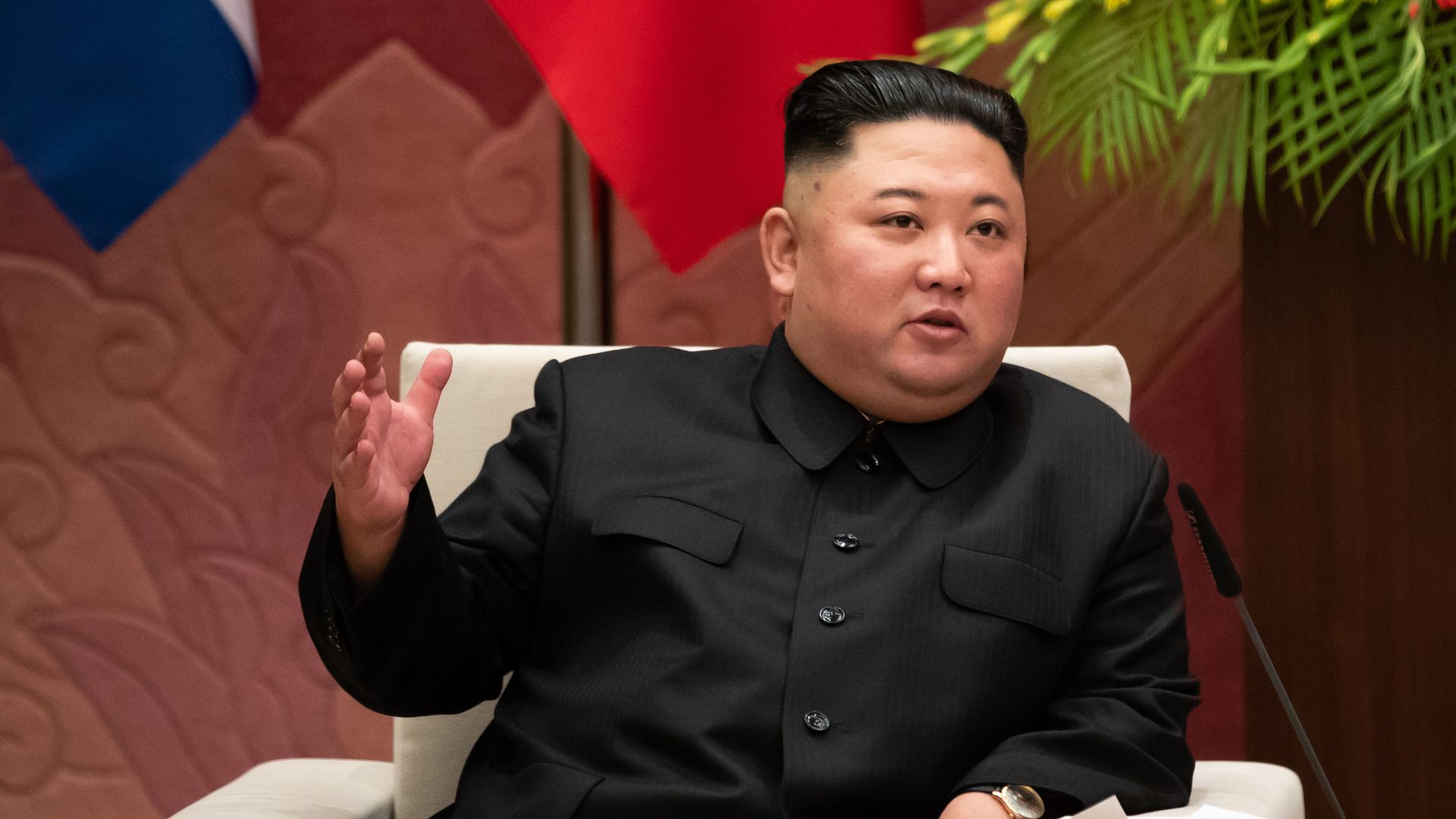 Photo of Kim Jong-un in a black outfit gesturing with his hand as he speaks