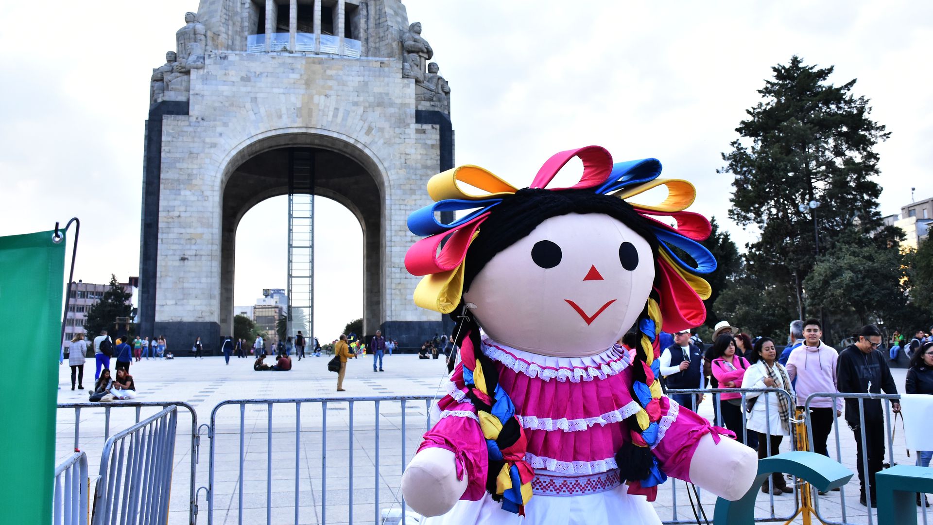 A 15-foot inflatable doll in Mexico with traditional dress in pink.