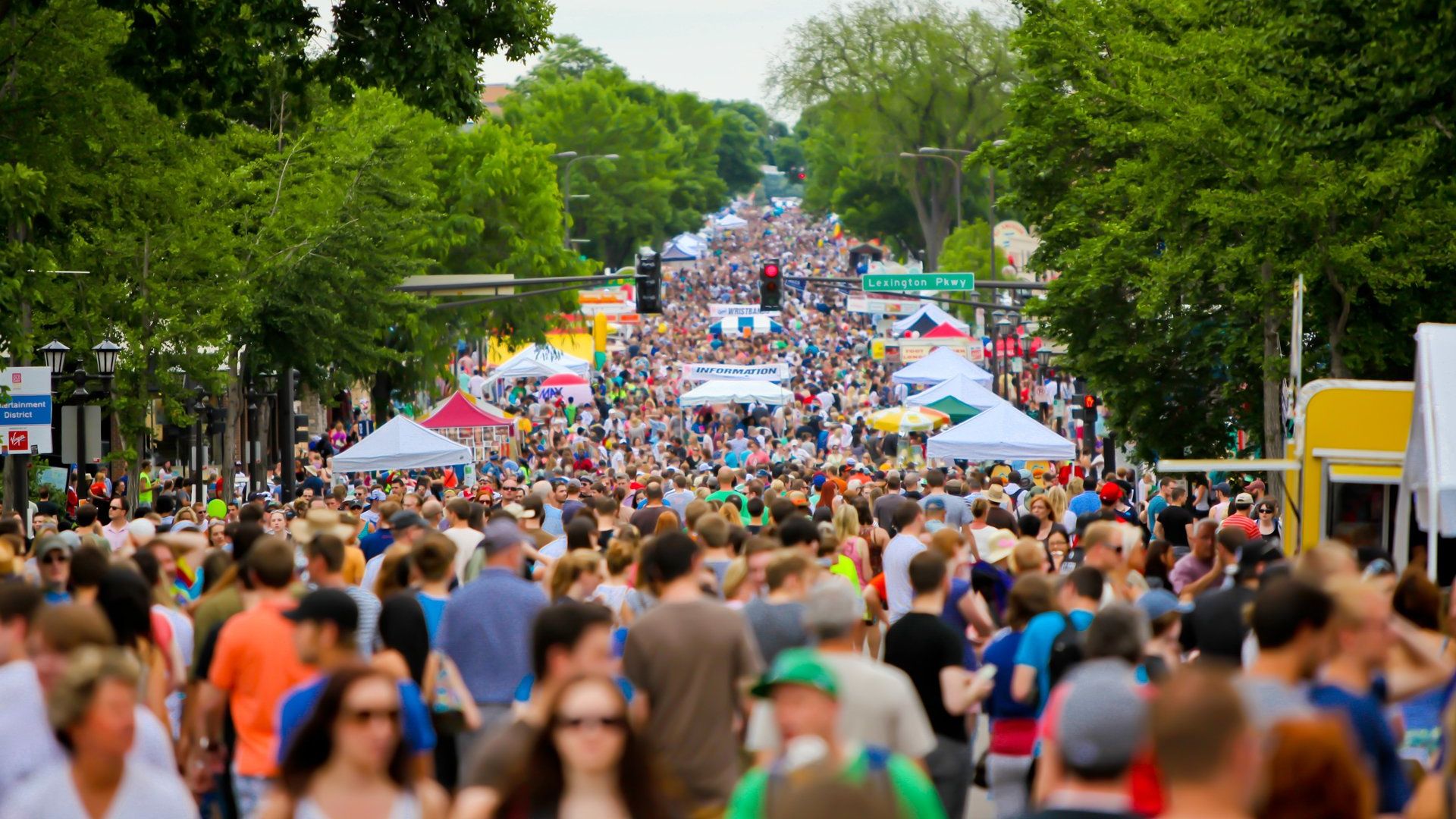 Grand Avenue in St. Paul on a summer day. The street is packed with people.