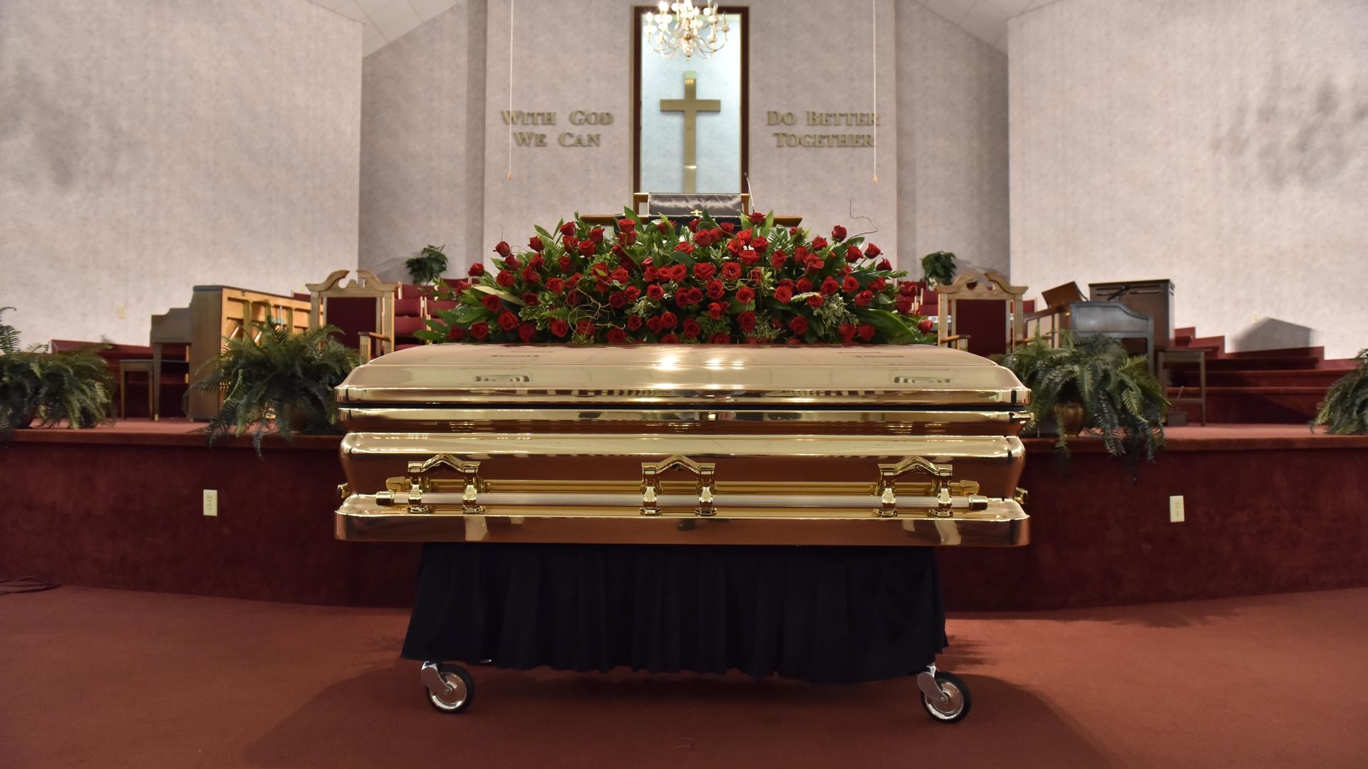 The remains of George Floyd are brought into Cape Fear Conference B Church in a gold casket