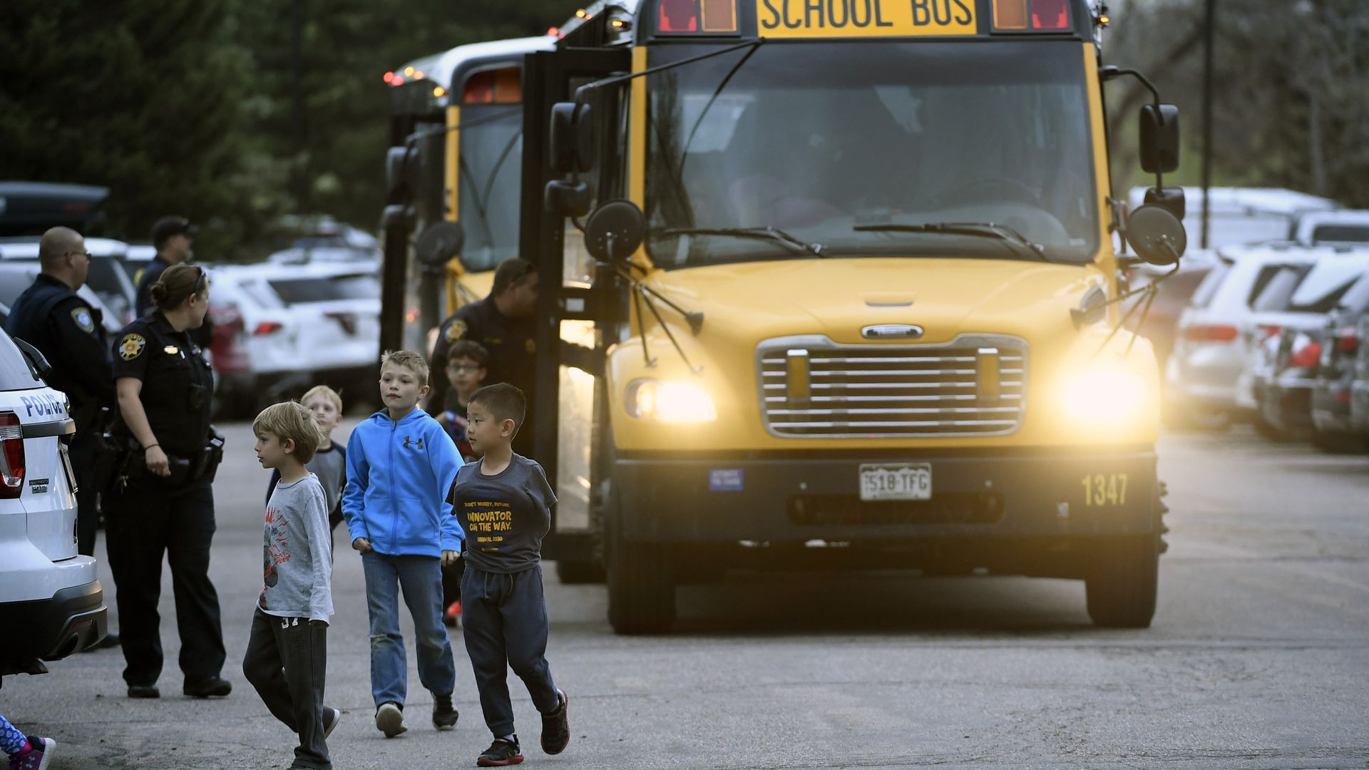 Kids of all ages are brought off buses to be reunited with their parents at the Highlands Ranch Recreation Center at Northridge after a shooting at the STEM school on Tuesday.