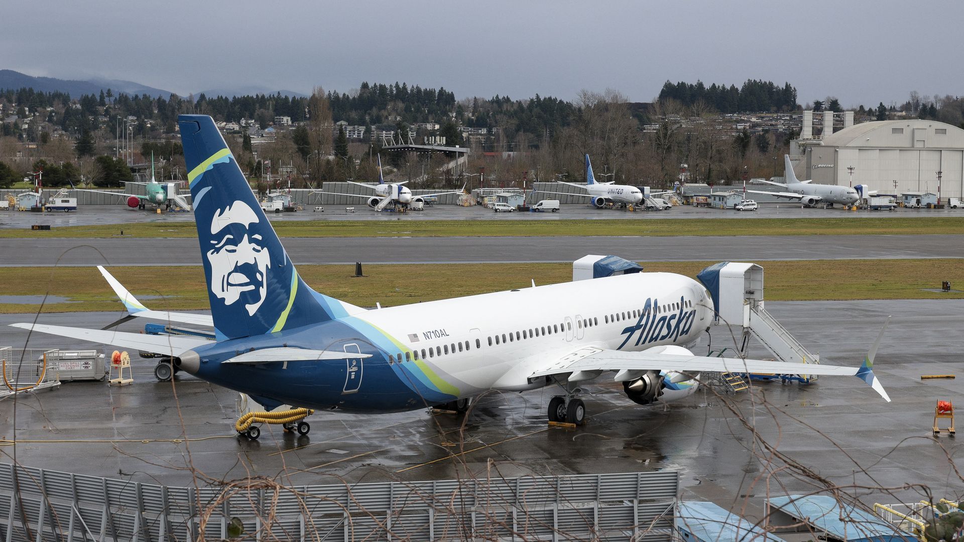 An airplane on the tarmac with a person's face on the rudder
