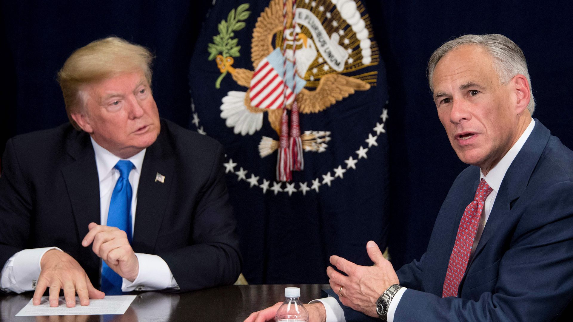 Texas Governor Greg Abbott sitting down and talking to President Donald Trump