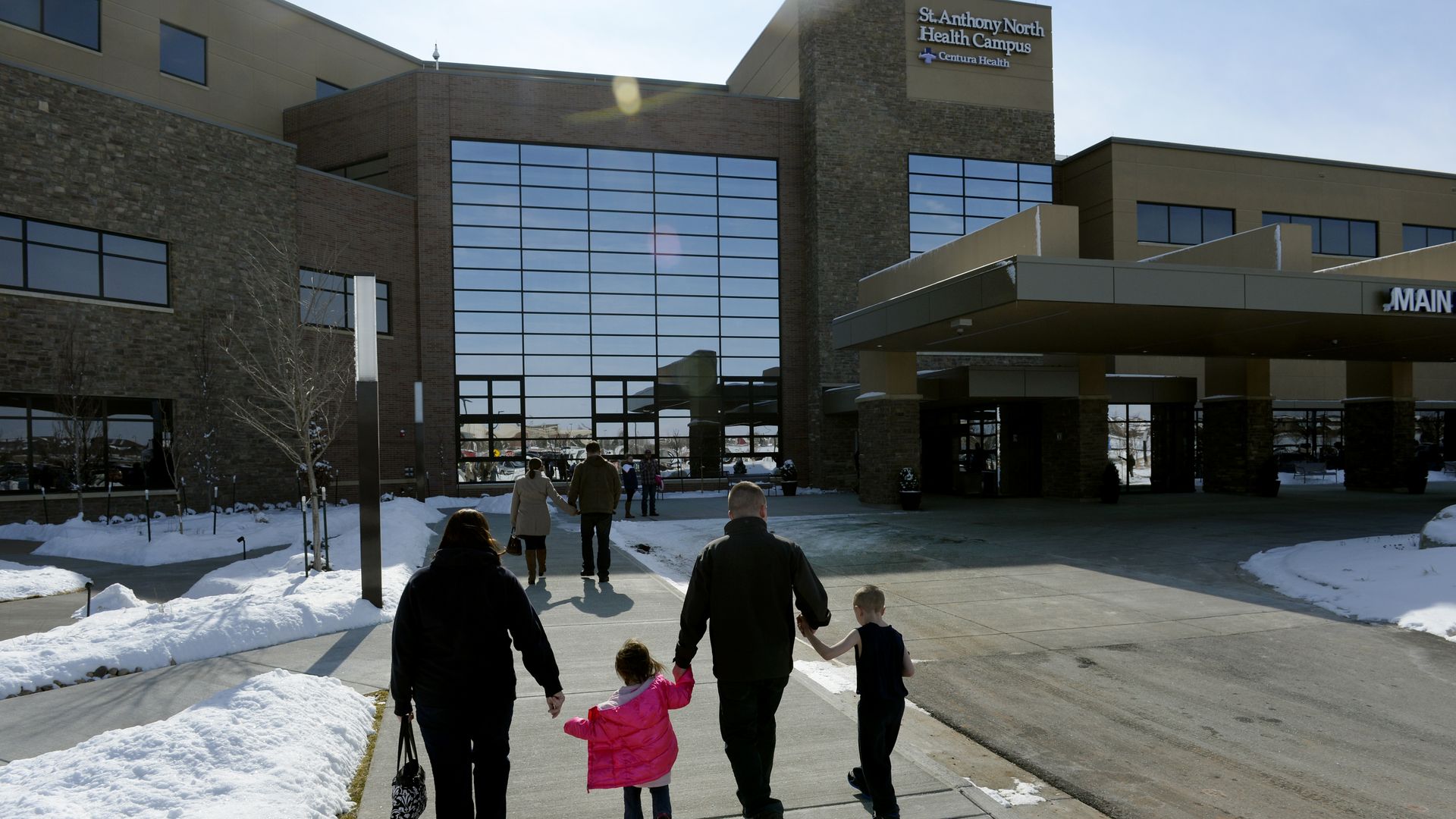 A family walks into the St. Anthony North Hospital in Colorado.