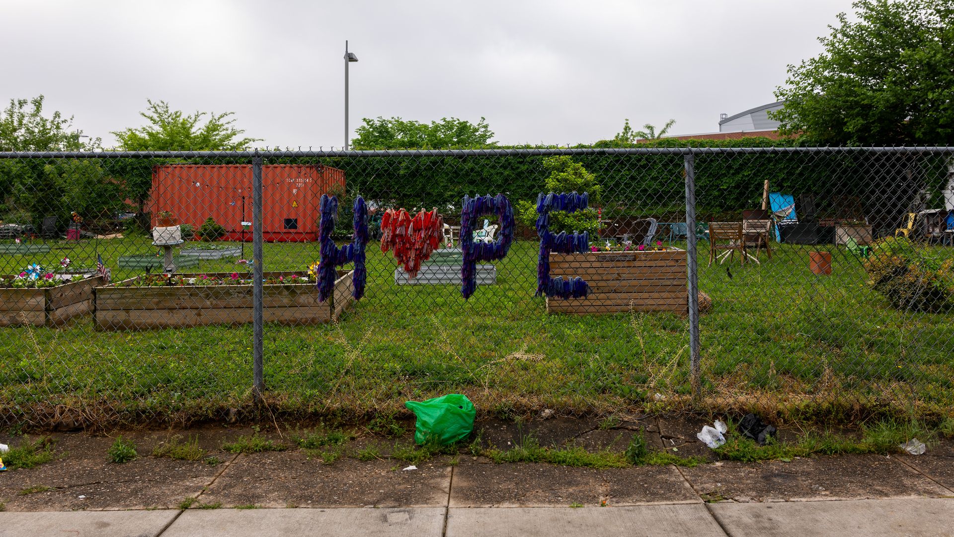 A fence with a sign displayed on it that says "Hope."