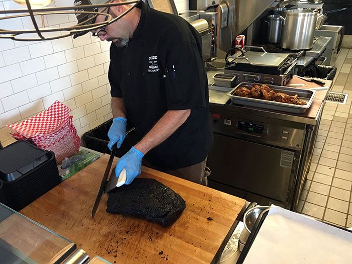 slicing-meat-at-midwood-smokeshack