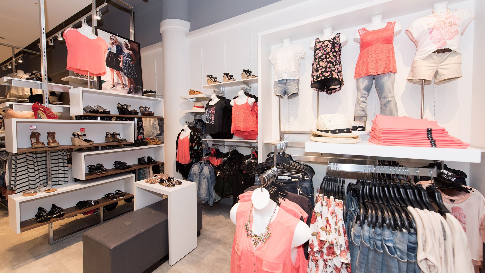 photo of clothing store Torrid featuring pink and white shirts on mannequins and denim jeans on racks