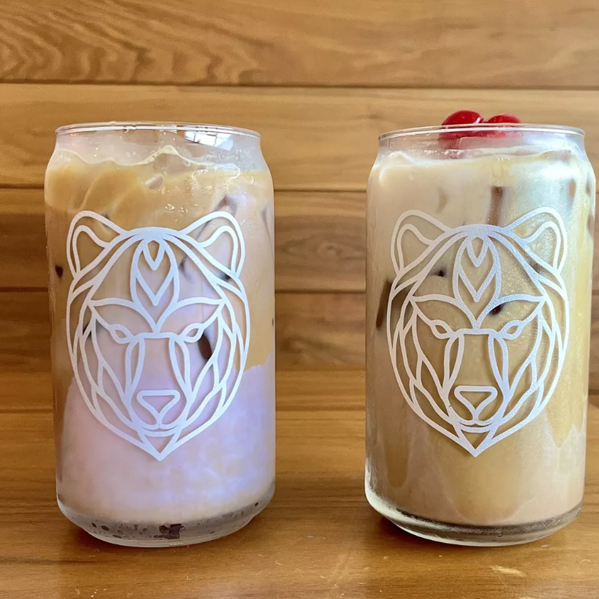 Two iced coffees in can shaped glasses 
