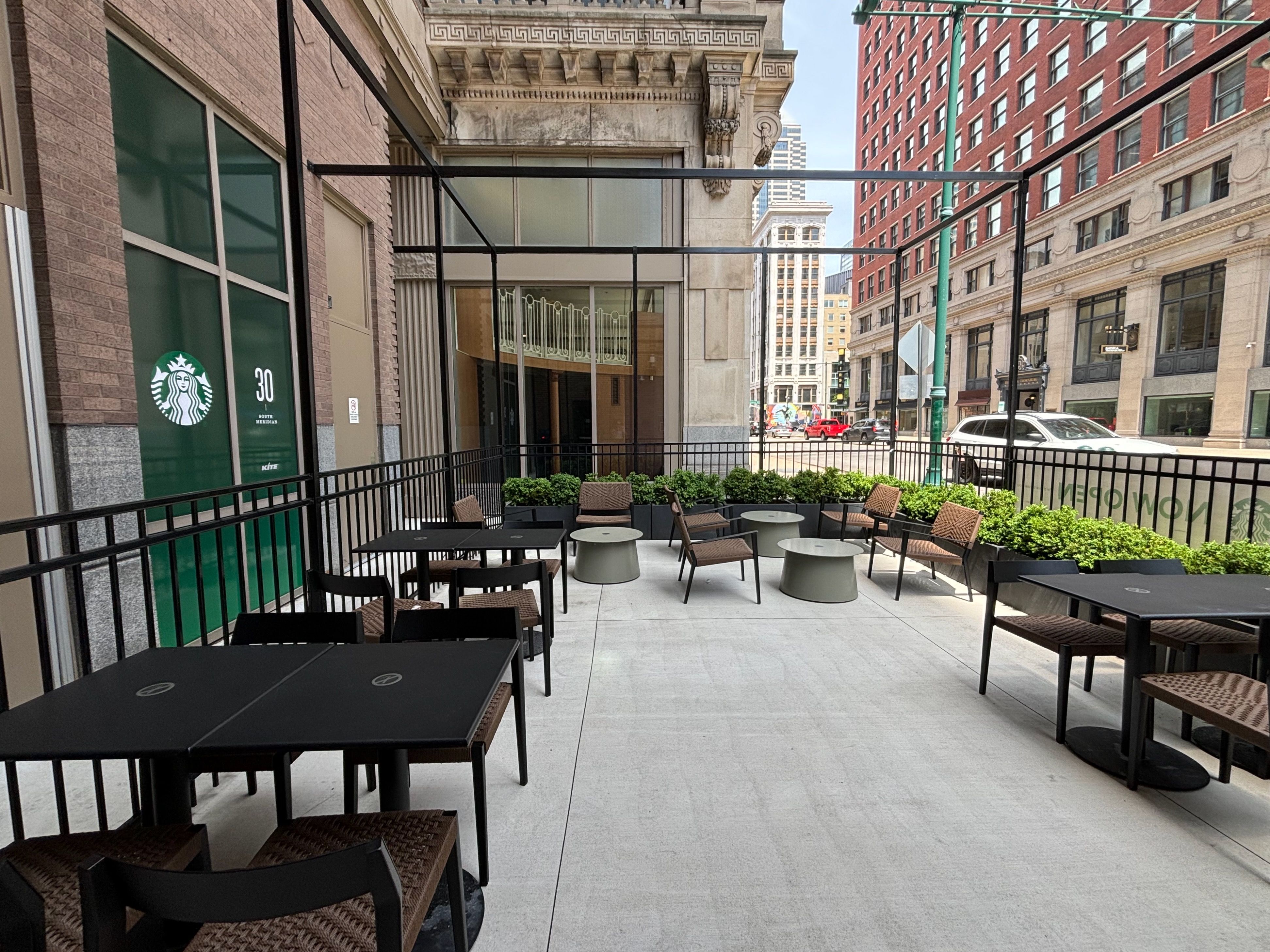 A patio with tables and plants