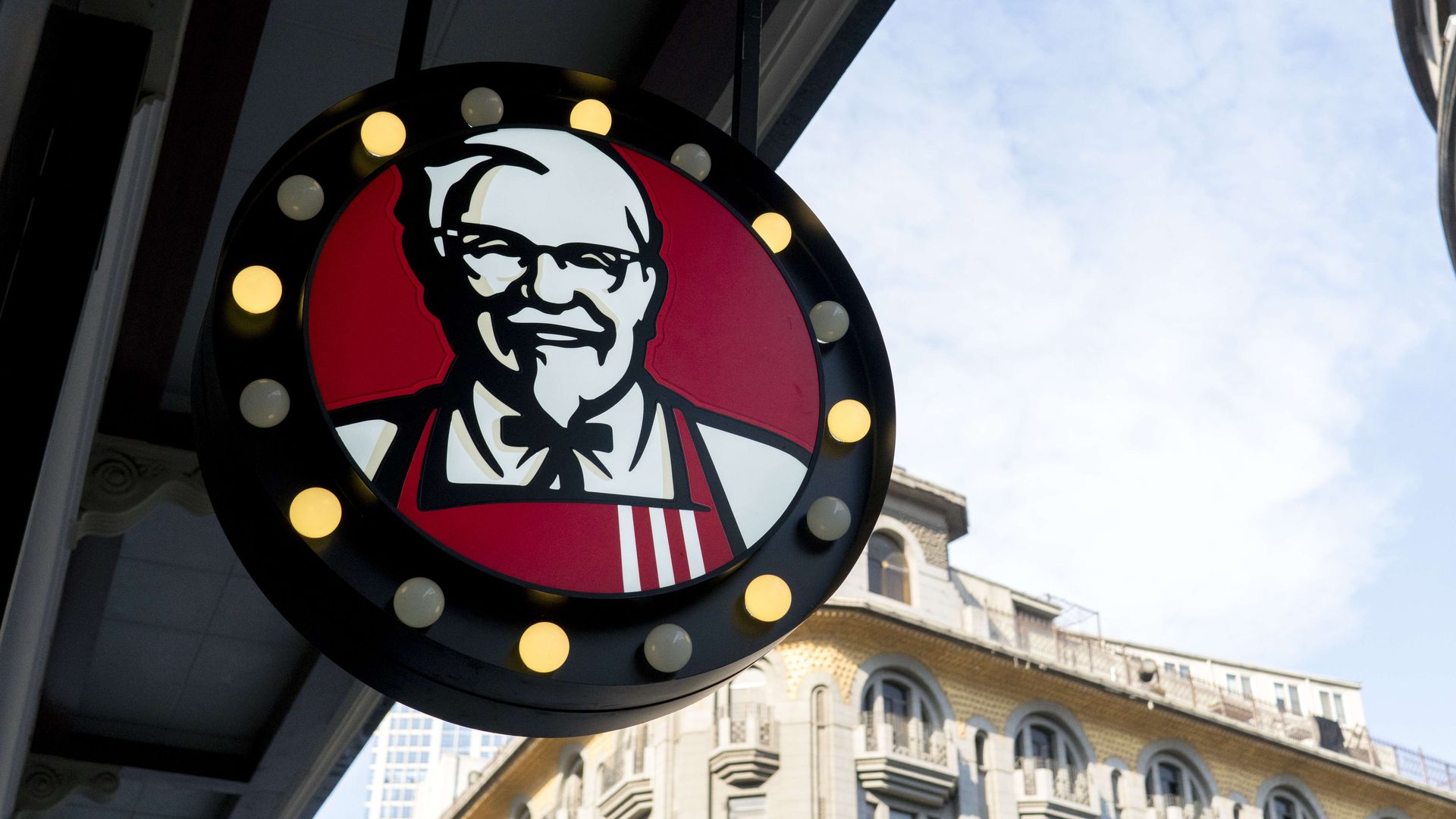Colonel Sanders portrait on logo of a KFC restaurant.
