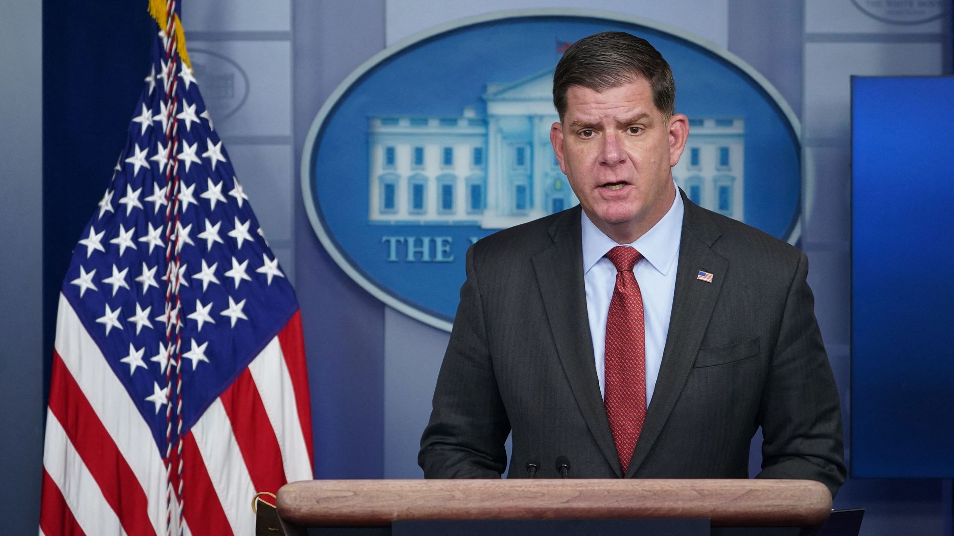 Marty Walsh stands behind the White House podium. 