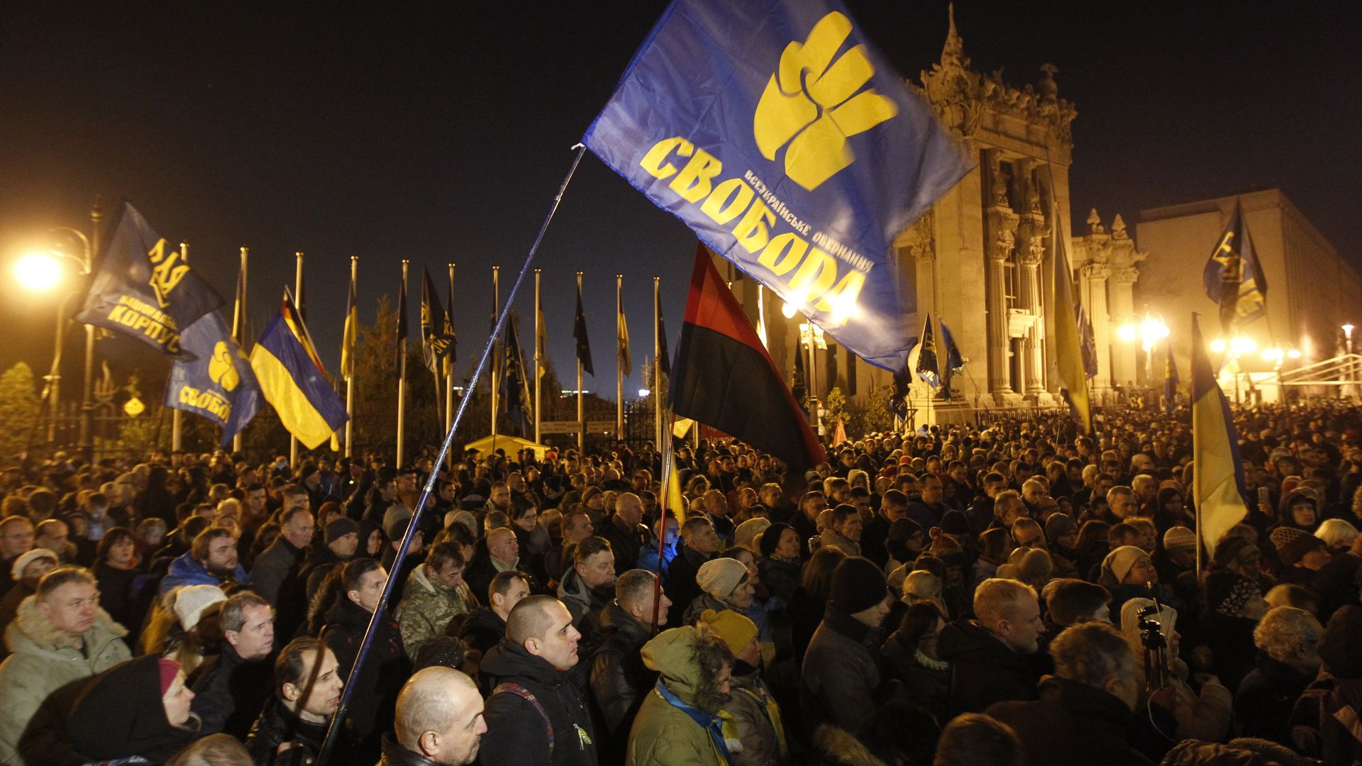 protestors at night in a public square in Kiev