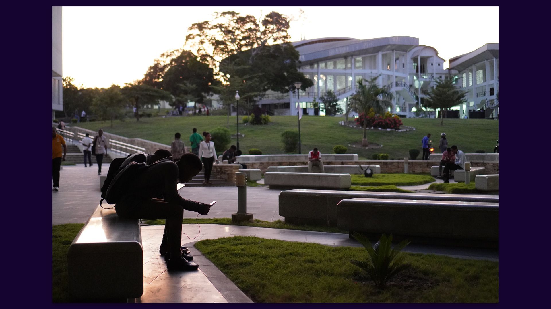 Students relax outside the library at Dar es Salaam University.