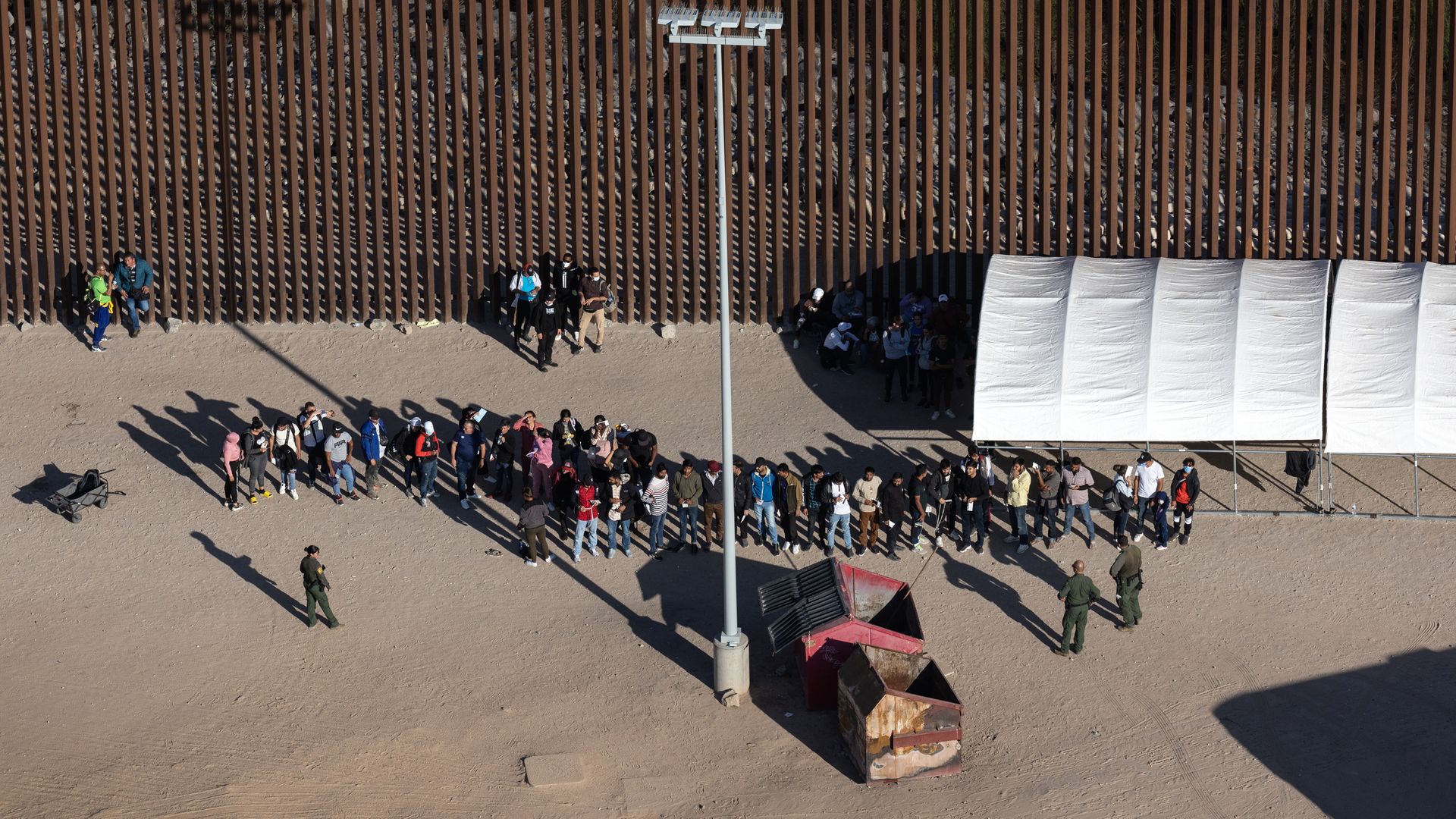 Immigrants await processing by U.S. Border Patrol agents.