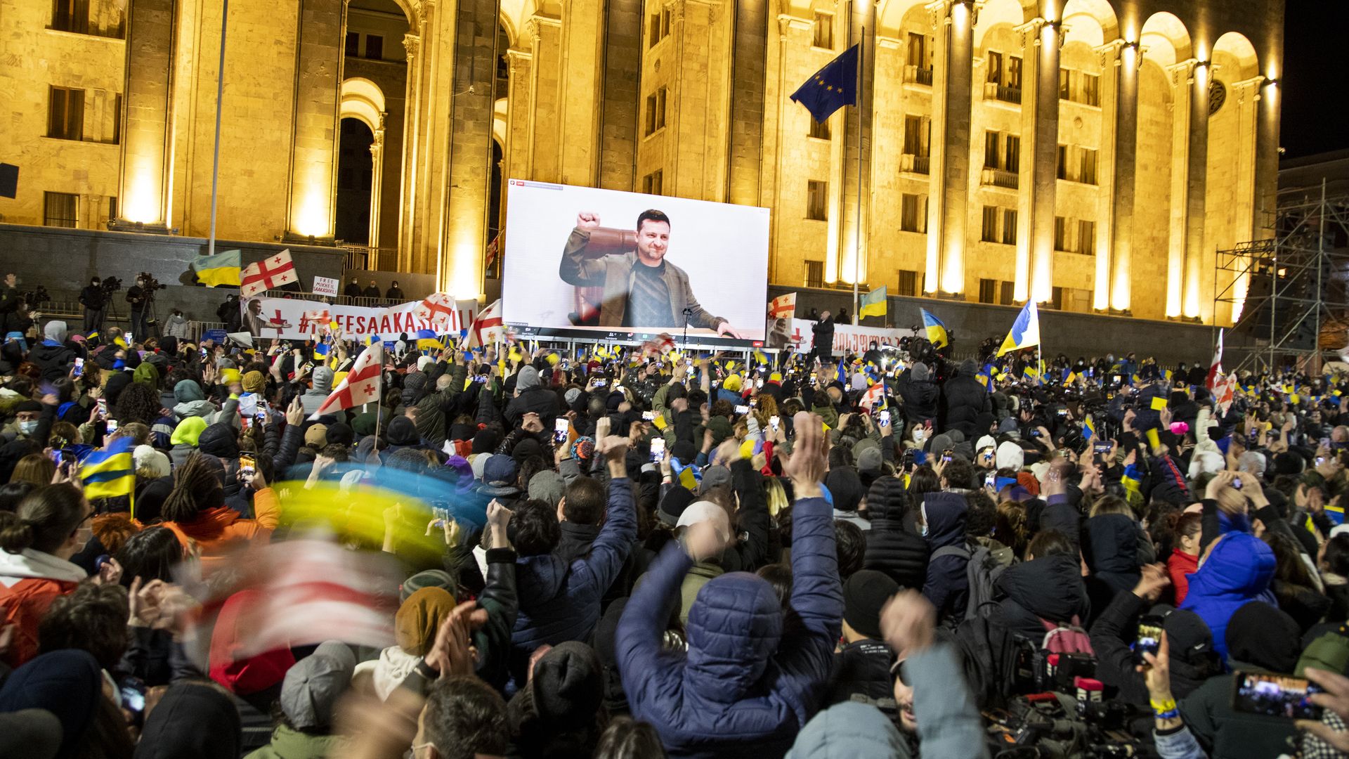 Ukrainian President Volodymyr Zelensky speech is streamed live on a big screen in front of Parliament during a rally in support of Ukraine on March 4, 2022 in Tbilisi, Georgia.