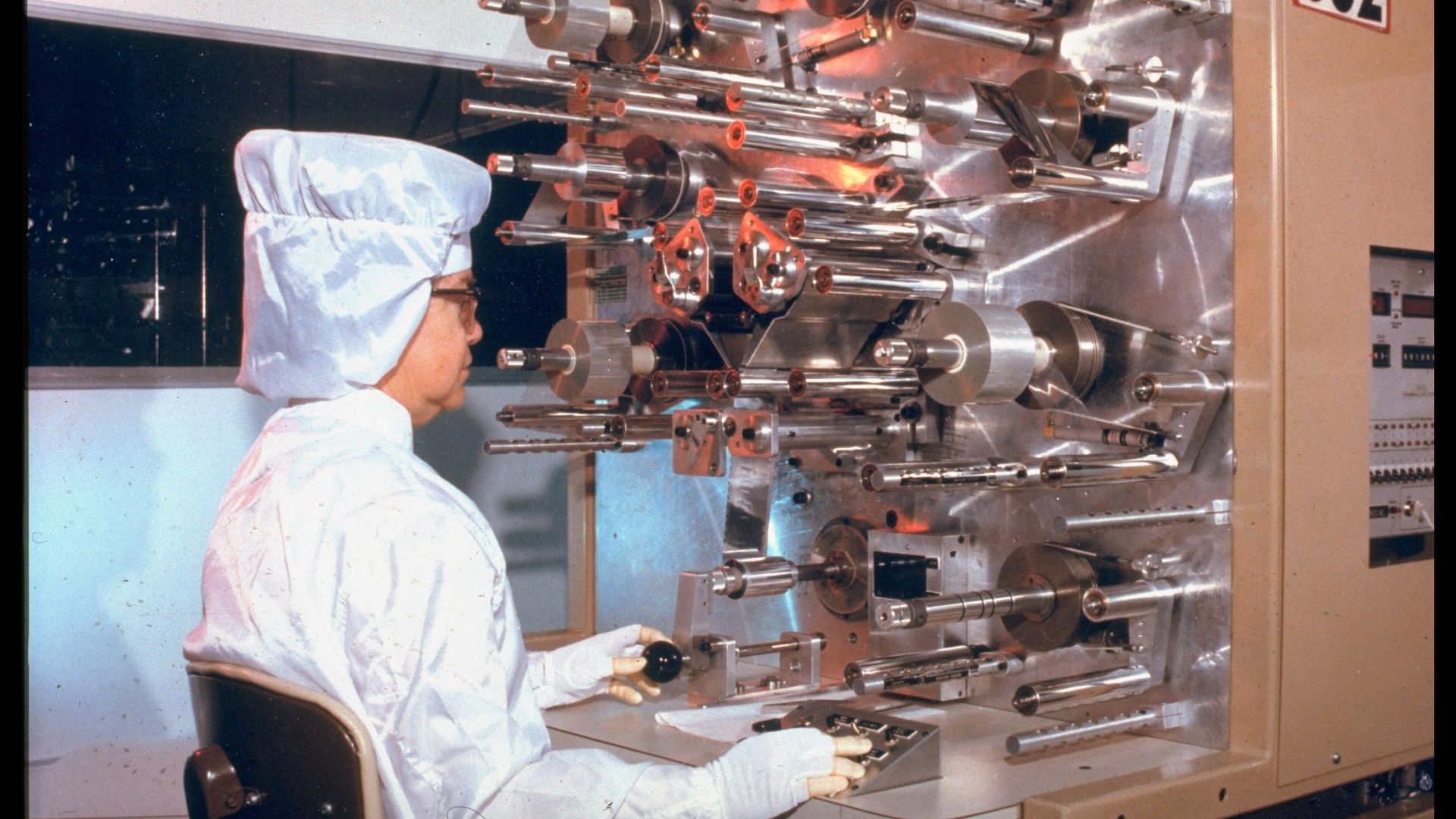 Clean-suited worker at Pinella DOE plant developing & producing (ultra-high reliability capacitators) neutron generators for nuclear weapons initiation. (Photo by Time Life Pictures/Department Of Ener