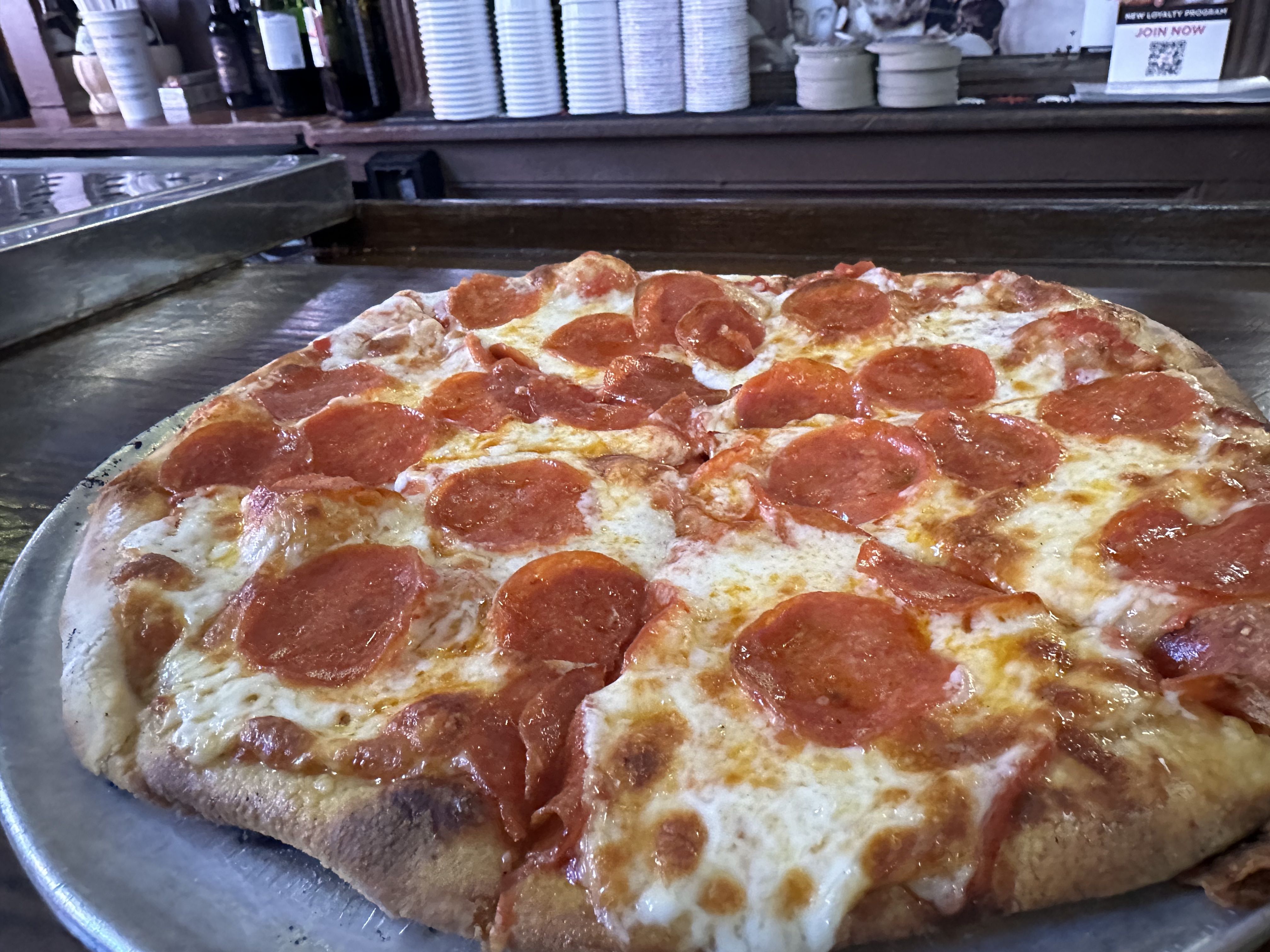 A greasy, cheesy pepperoni pizza pie from Regina Pizzeria, the original location in Boston's North End. 