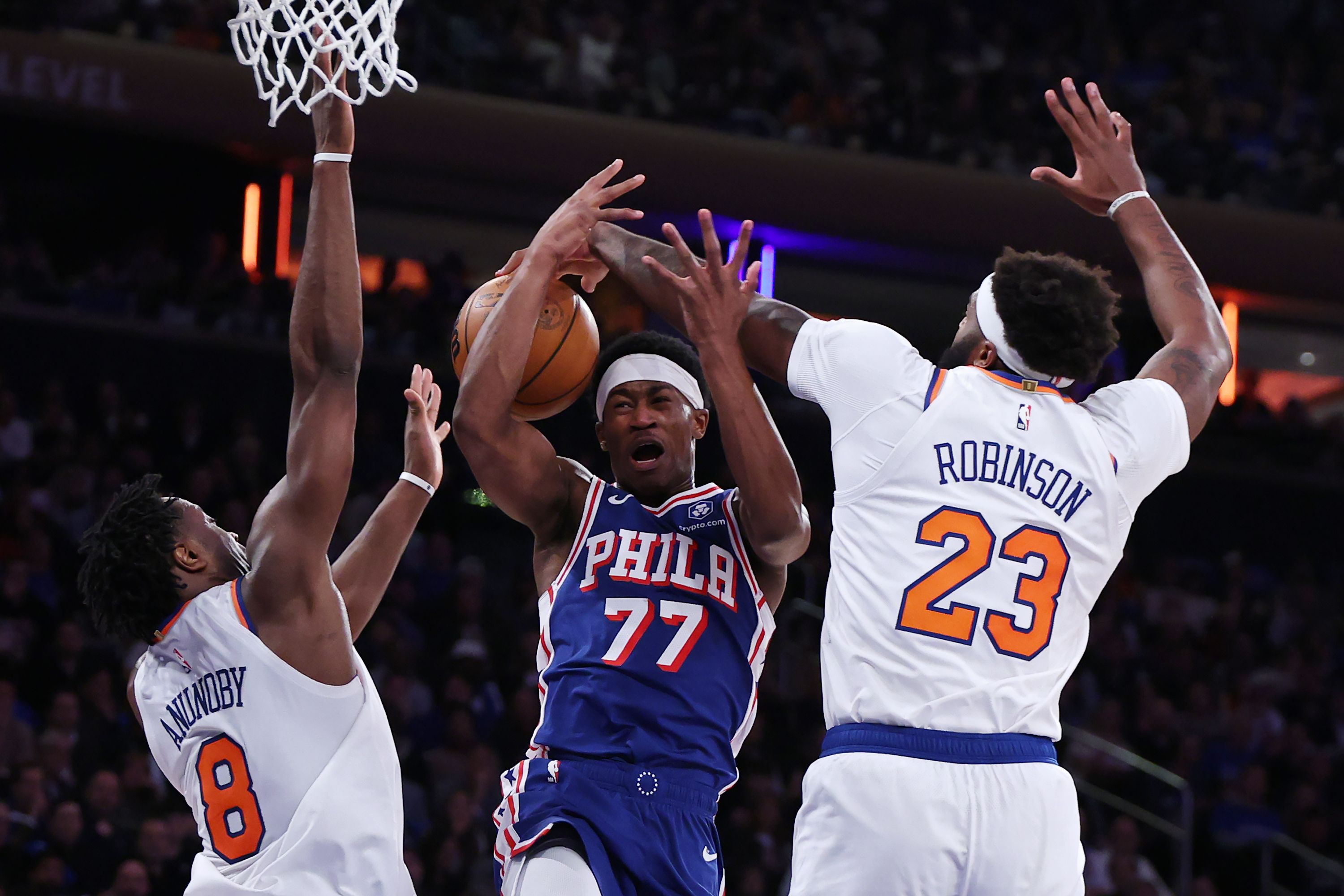 The Sixers' VJ Edgecombe loses the ball while challenging the Knicks' Mitchell Robinson and Og Anunoby at the rim in the teams' second-round playoff game.