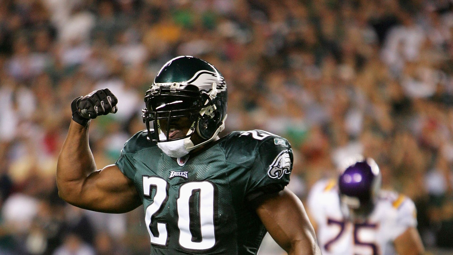 Former Eagles great Brian Dawkins flexing his bicep.