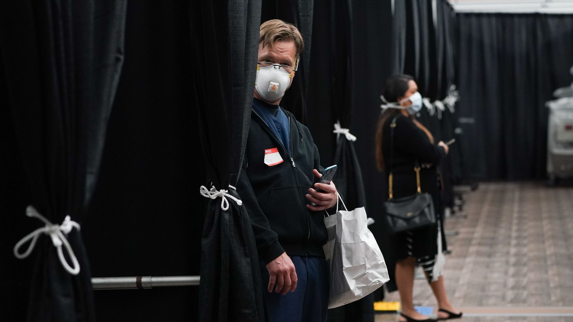 In this image, a man wears a face mask