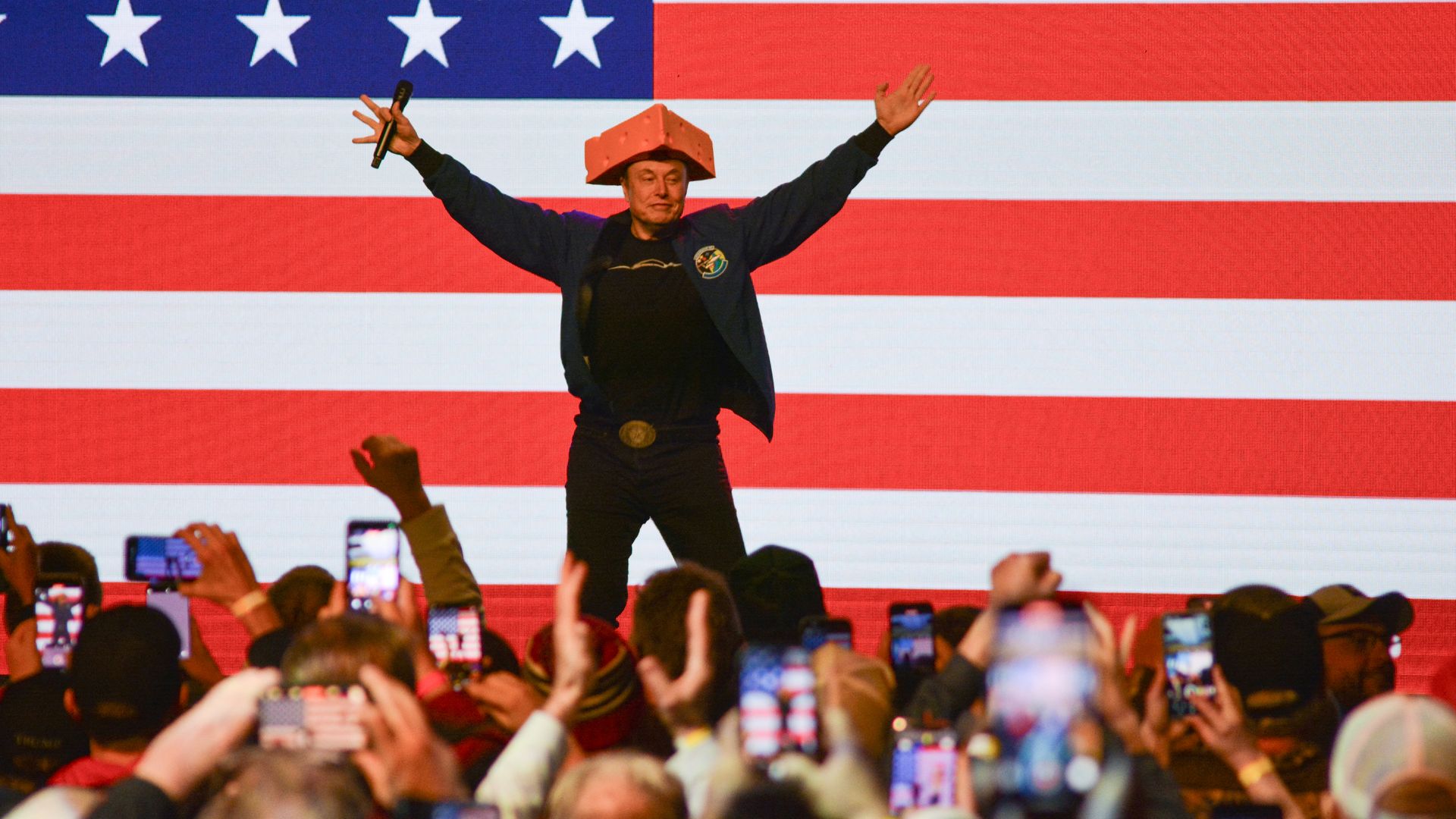  Elon Musk wears a Cheesehead hat as he speaks during a town hall in Green Bay, Wisconsin on Sunday.