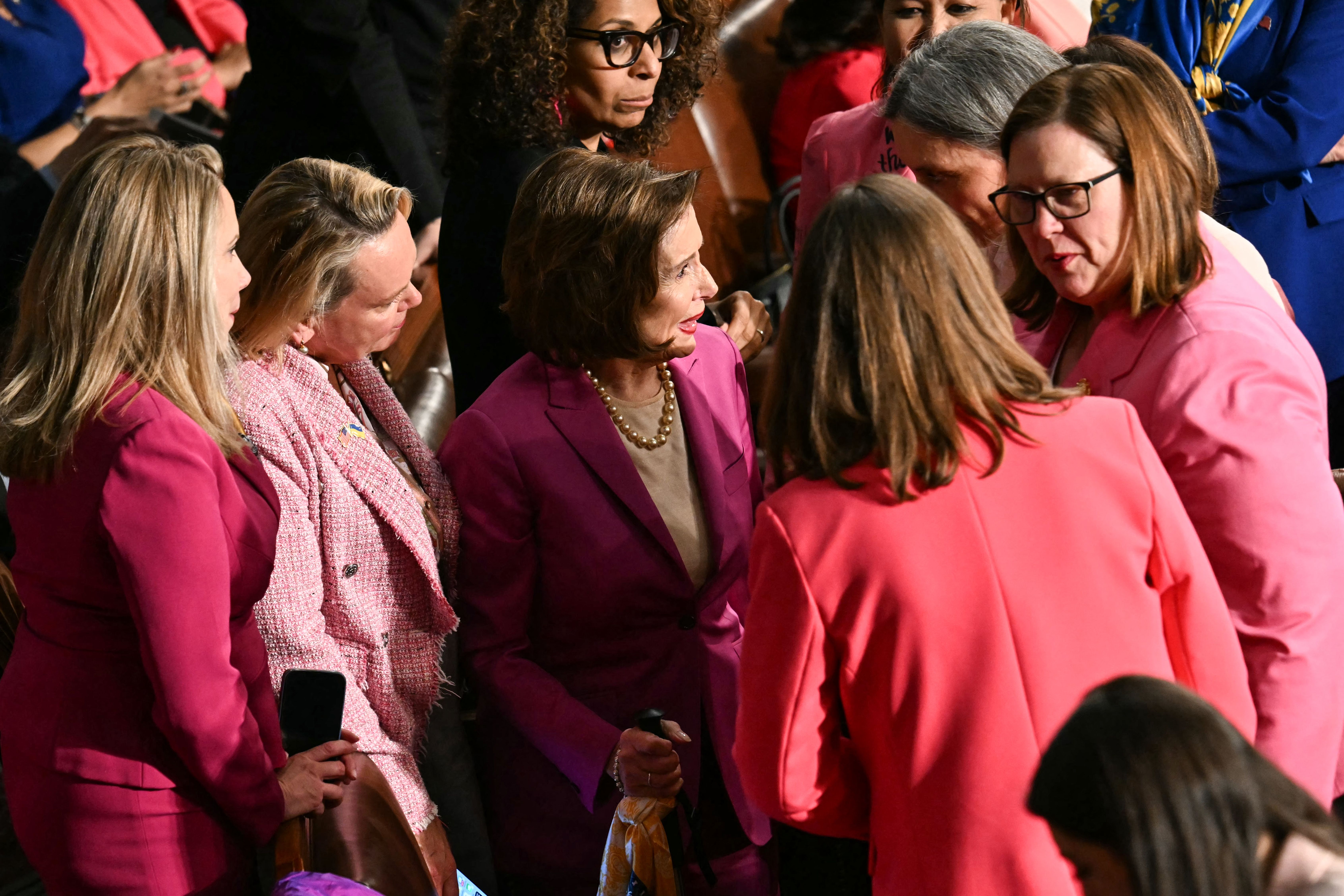 Nancy Pelosi, Democrat from California, gathers with other female members wearing pink ahead of US President Donald Trump's address to a joint session of Congress in the House Chamber of the US Capitol in Washington, DC, on March 4, 2025. 