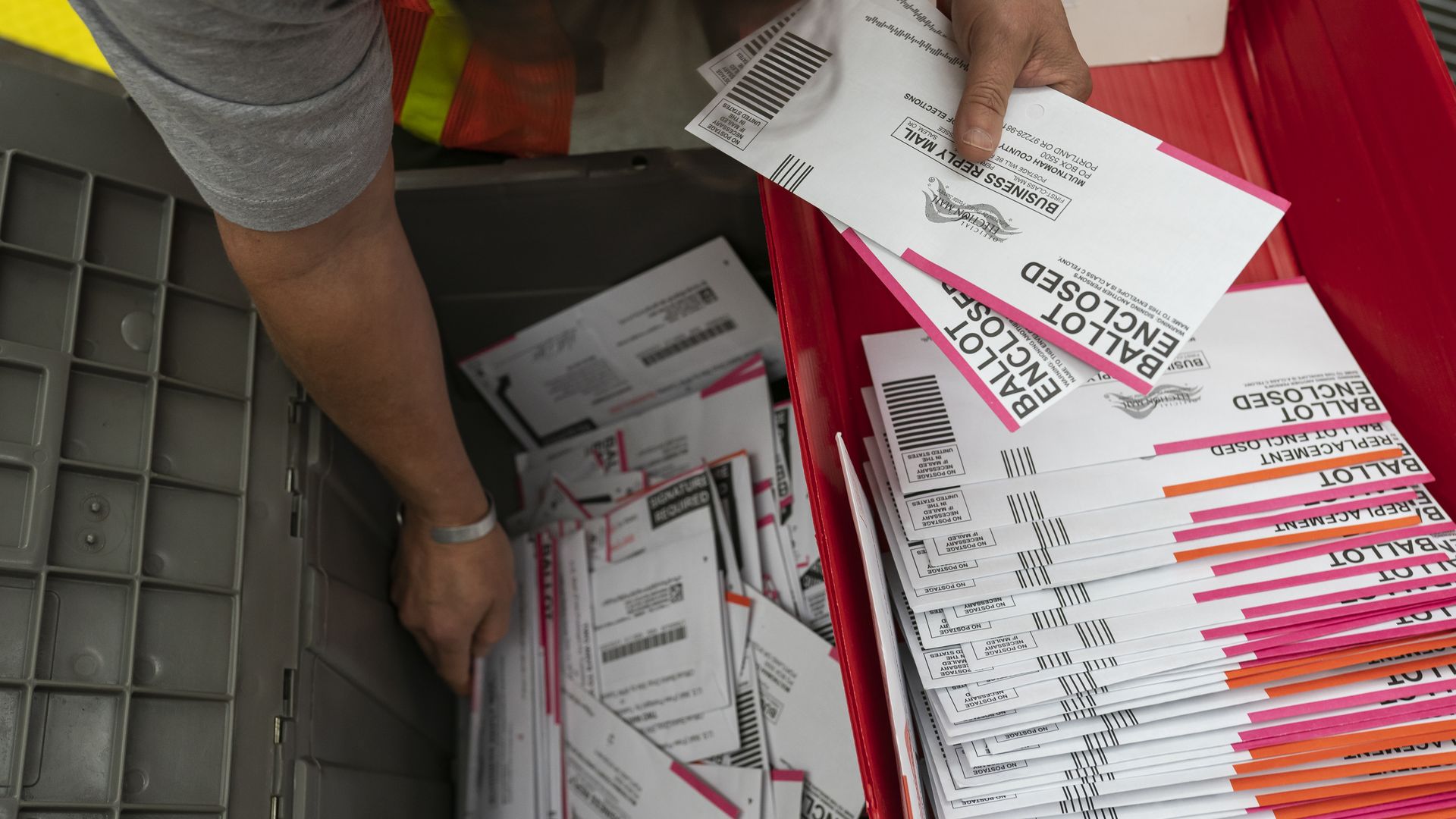 An election worker sorts submitted ballots at the Multnomah County Elections Office