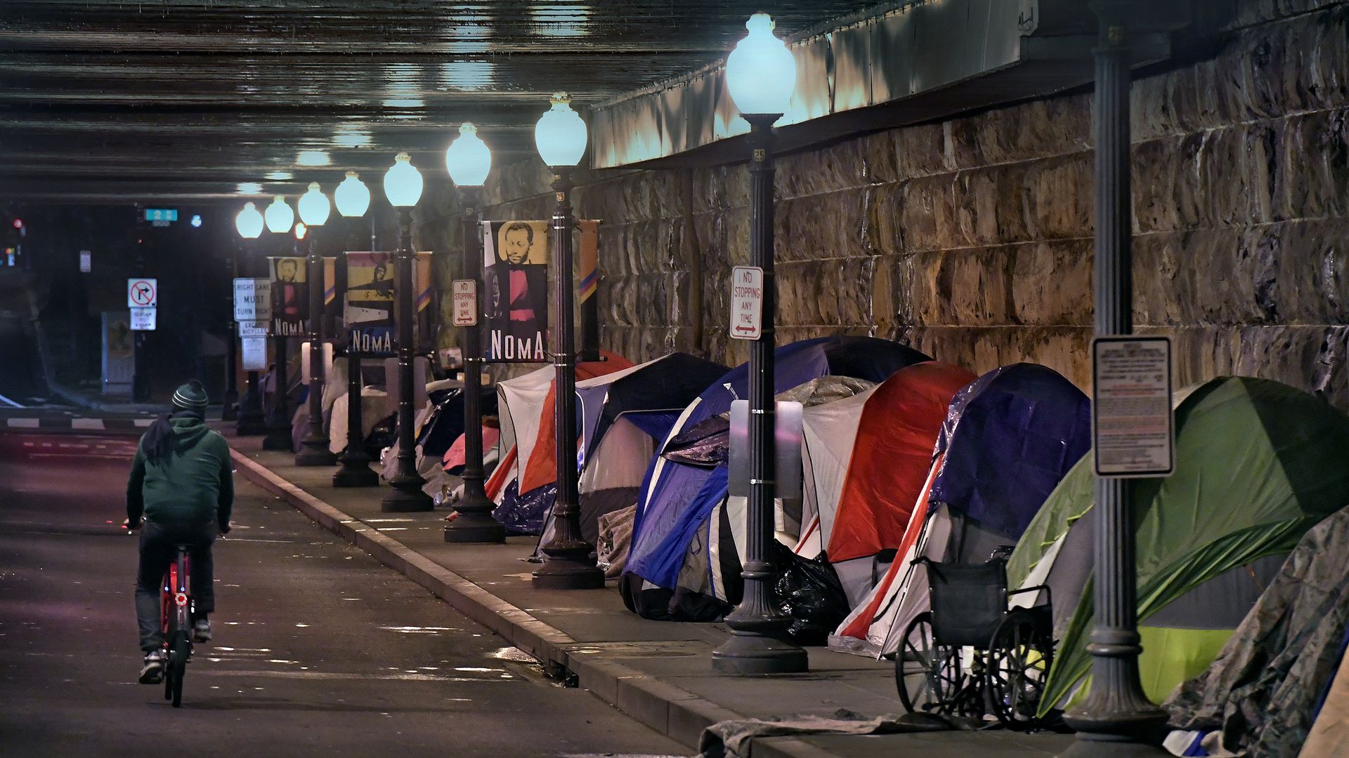 Tents for homeless people a street under an overpass in D.C.