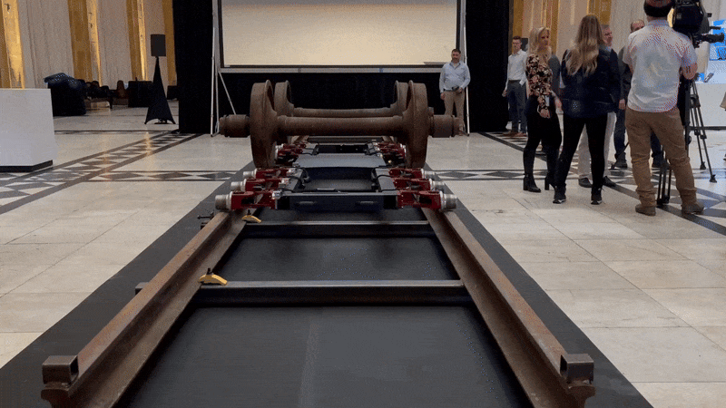 A Rail Ghost robotic sled slides underneath train wheels at a Wabtec event in Pittsburgh