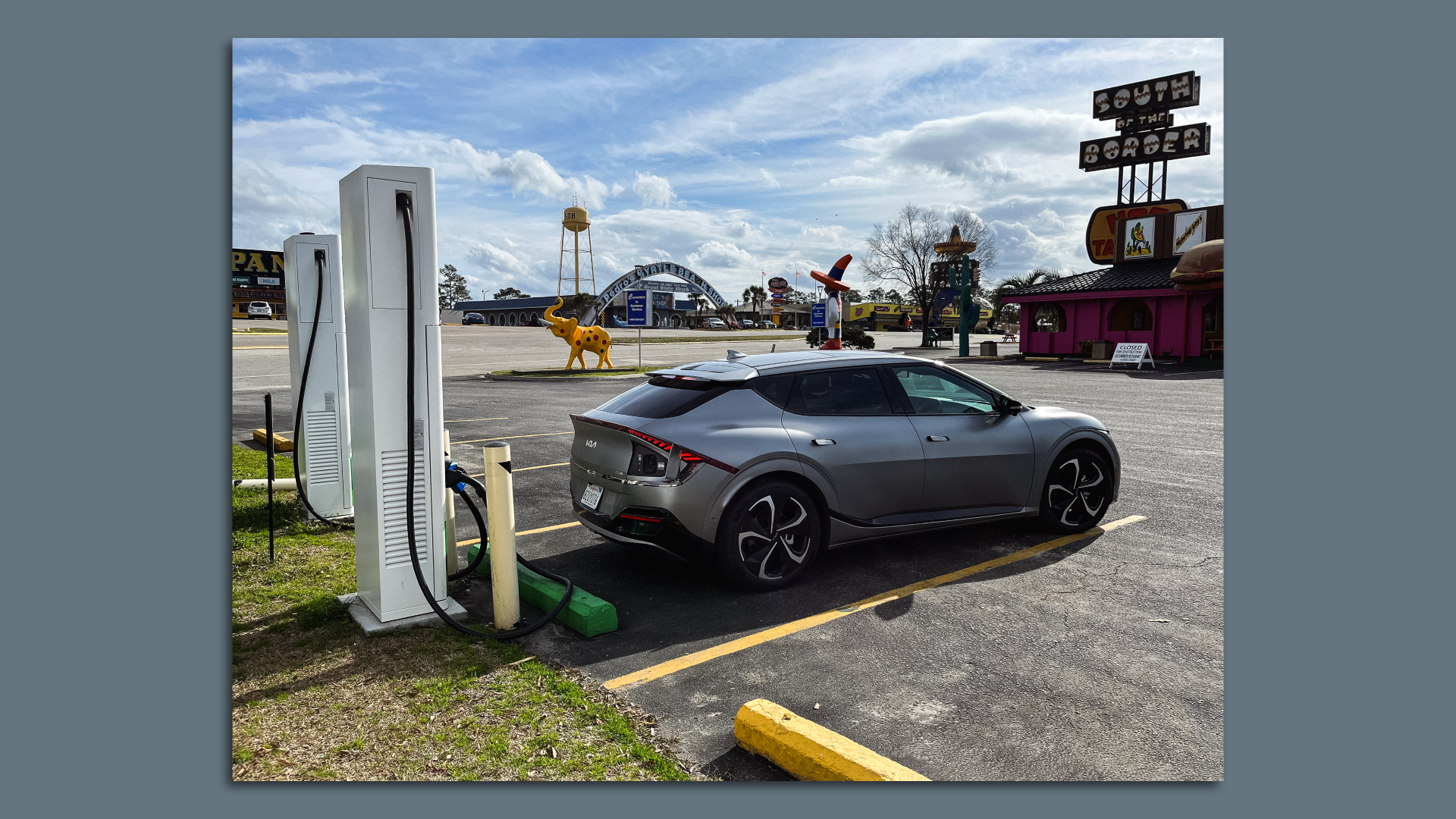 A Kia EV6 electric car recharging at a kitschy roadside attraction called South of the Border in South Carolina.