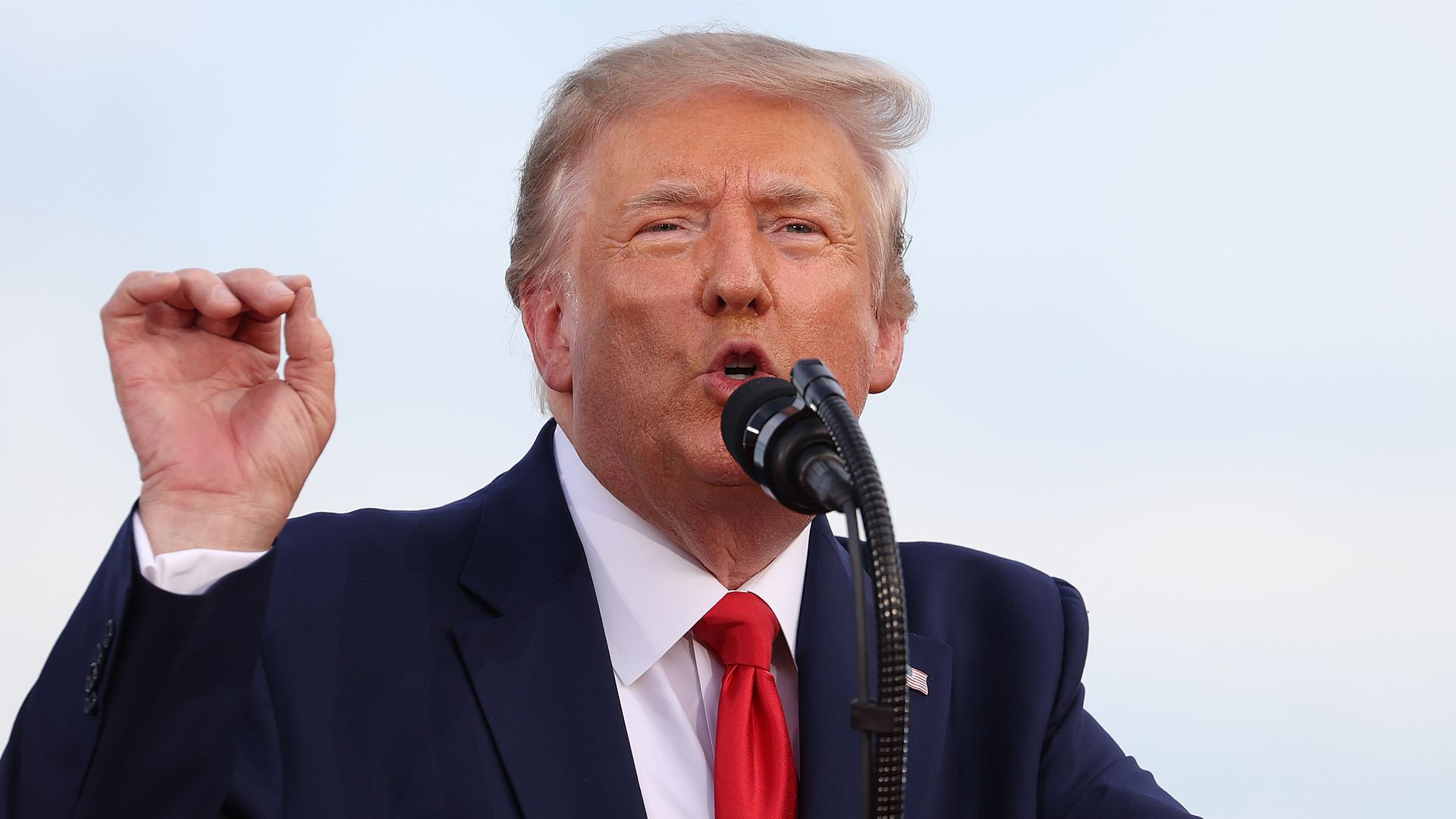 President Trump speaking into a mic