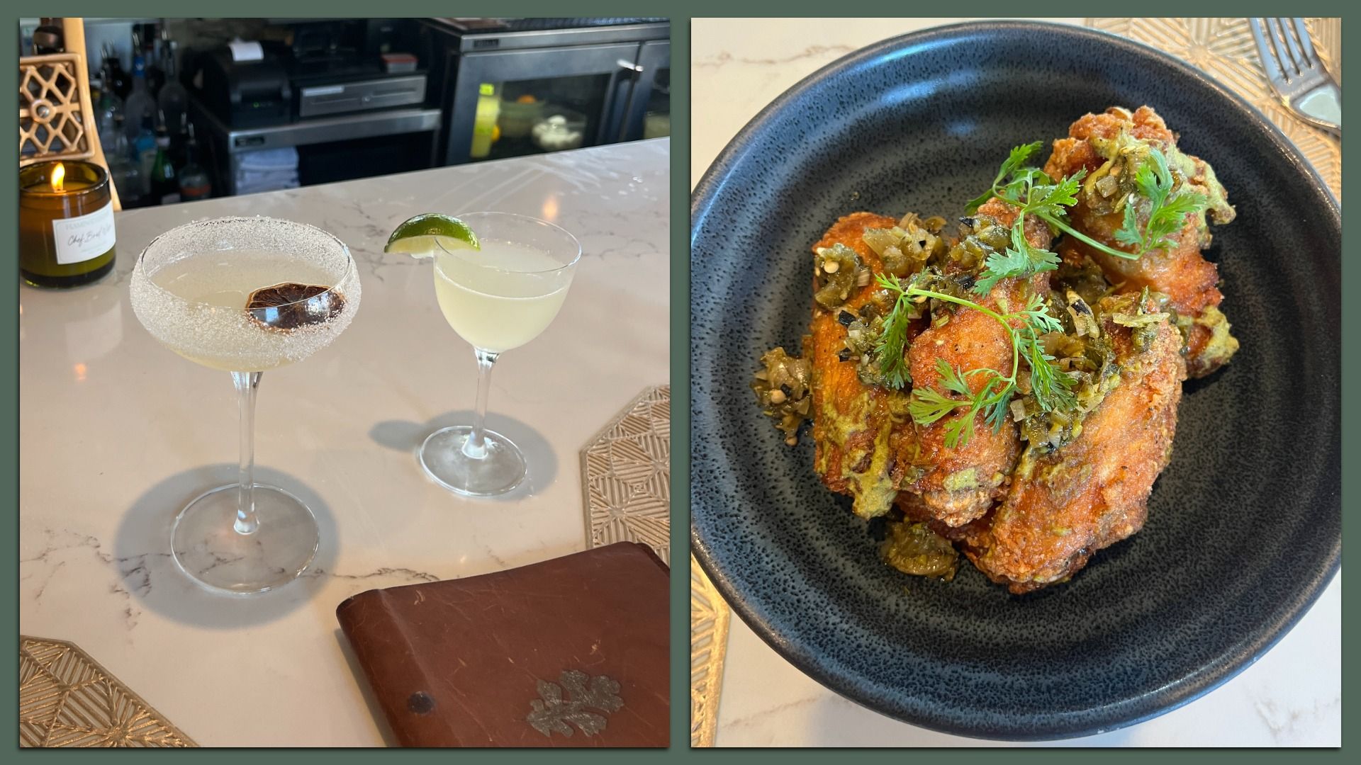 Two cocktails on a marble bar counter, one with a salt rim and dried citrus; the other with a lime wedge. Next to them, a black bowl with crispy fried chicken wings garnished with herbs.