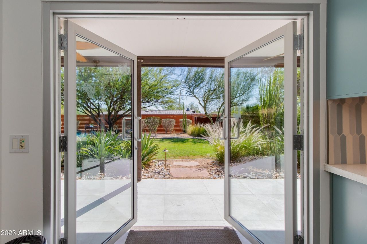 Doors opening to a backyard. 