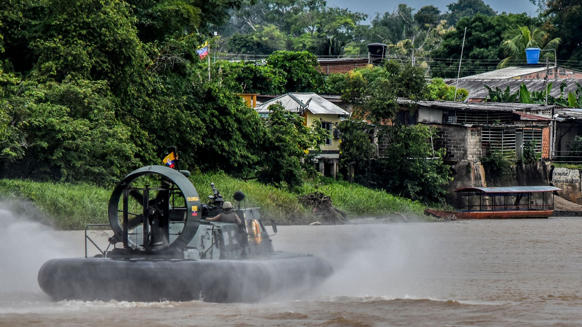 Colombian soldiers cruise the Arauca river in Arauquita municipality, Arauca department, Colombia, on March 26, 2021. 