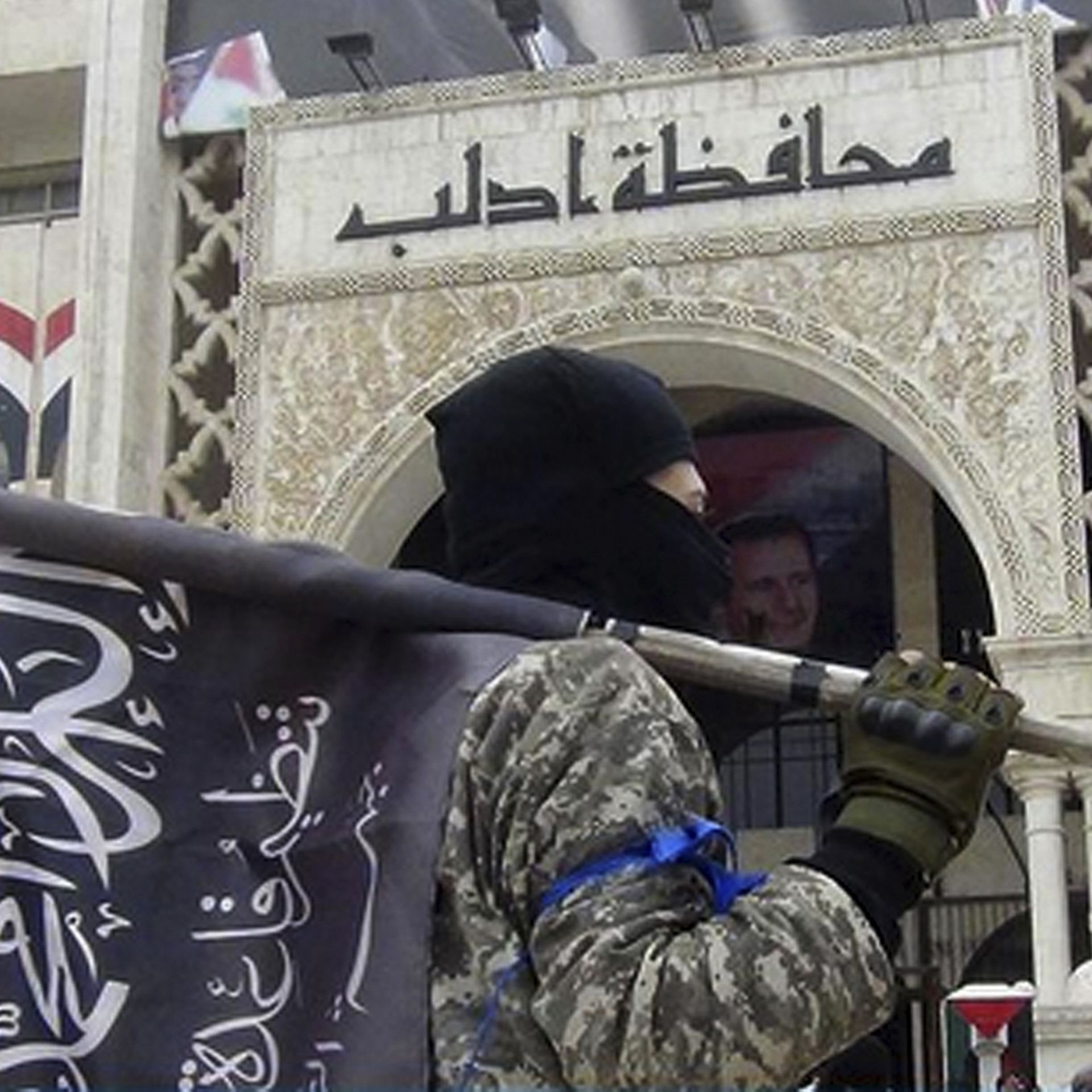 Masked al-Nusra fighter with flag