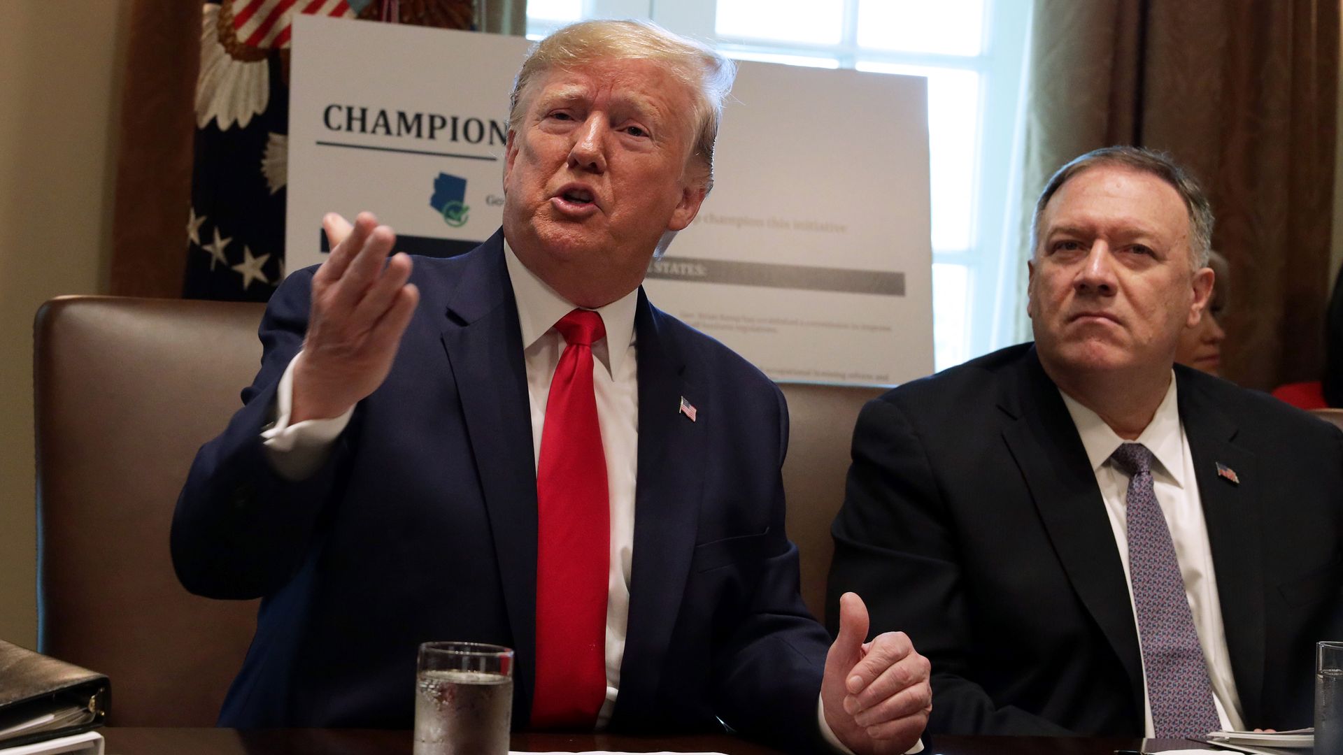 President Donald Trump speaks as Secretary of State Mike Pompeo listens during a cabinet meeting