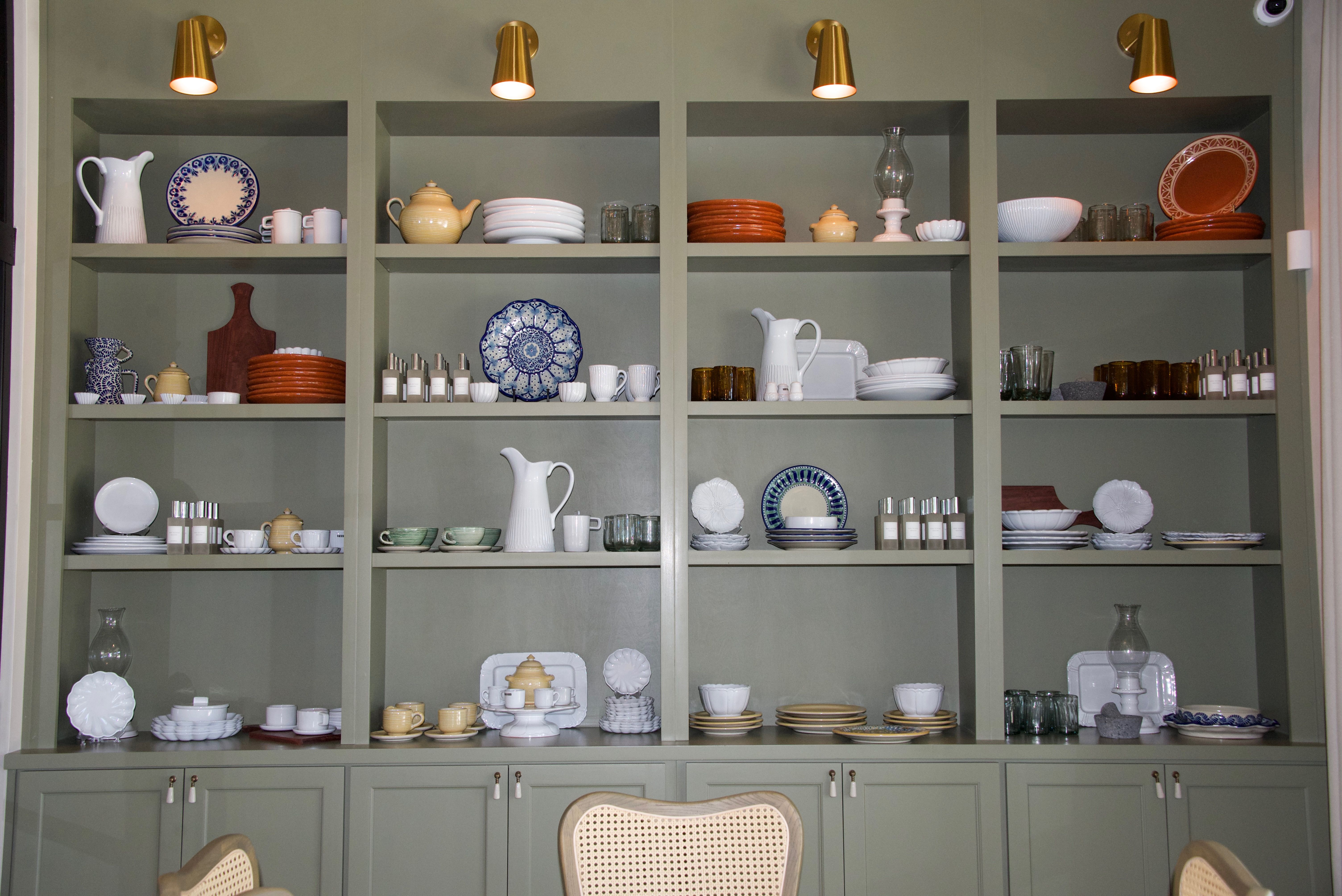 A wall of shelving with dishes. 
