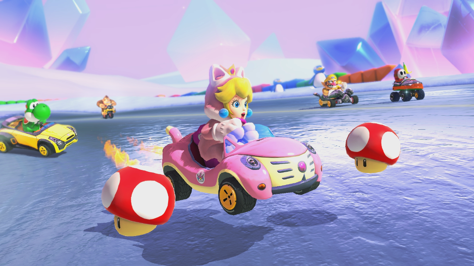 Video game screenshot of a blonde princess in a pink car racing against other Nintendo characters