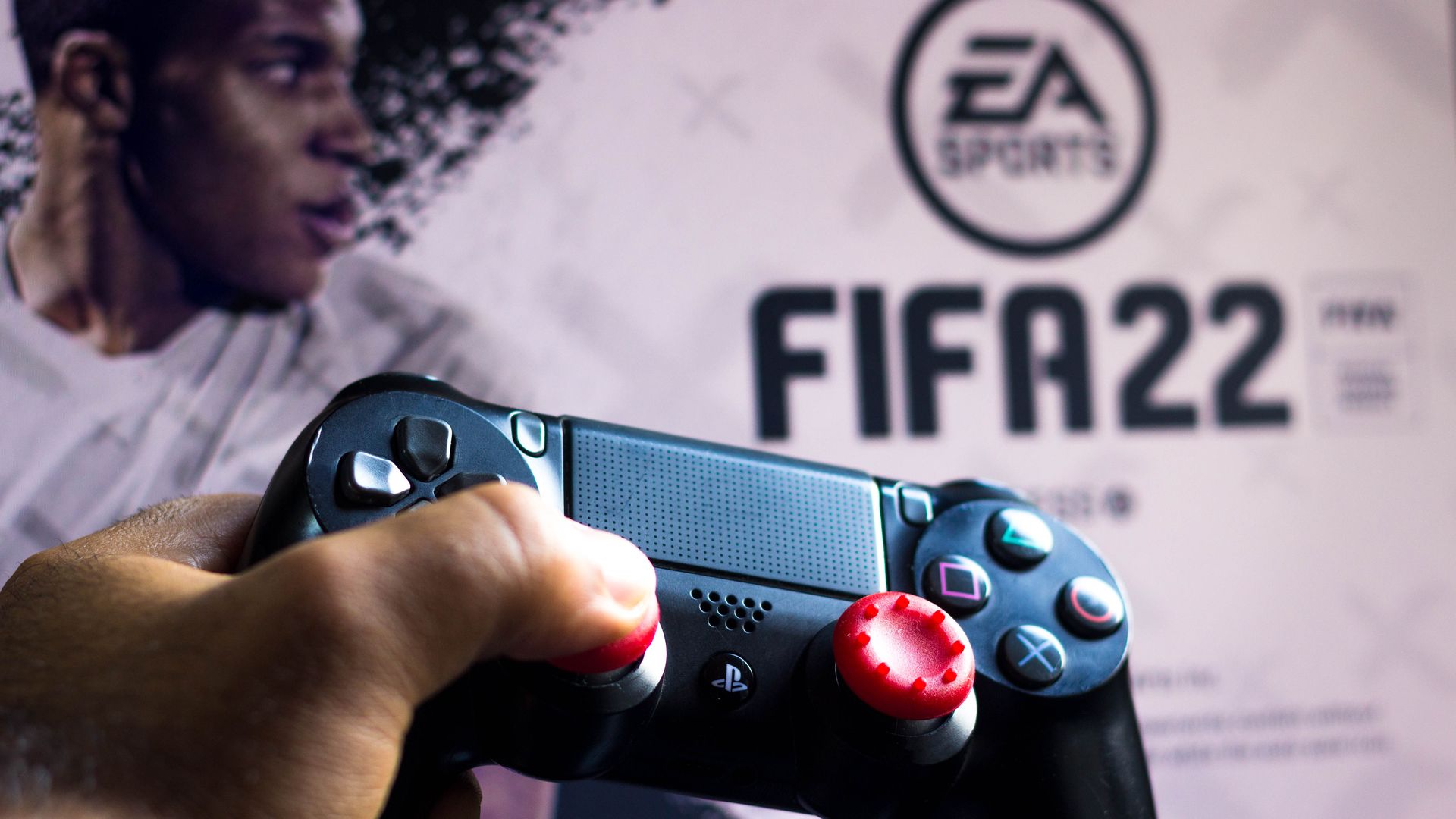 FIFA 22 logo with a controller in front of it 