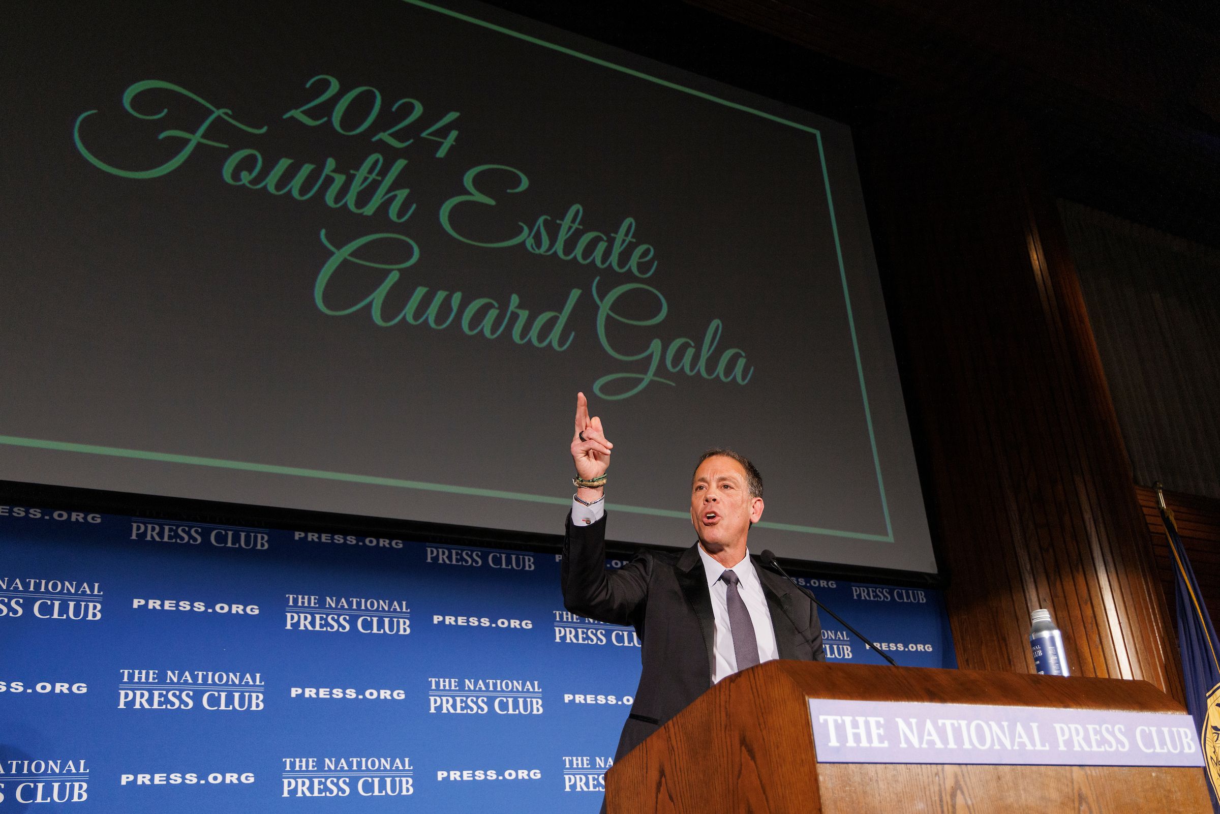 Jim VandeHei speaks from behind a podium
