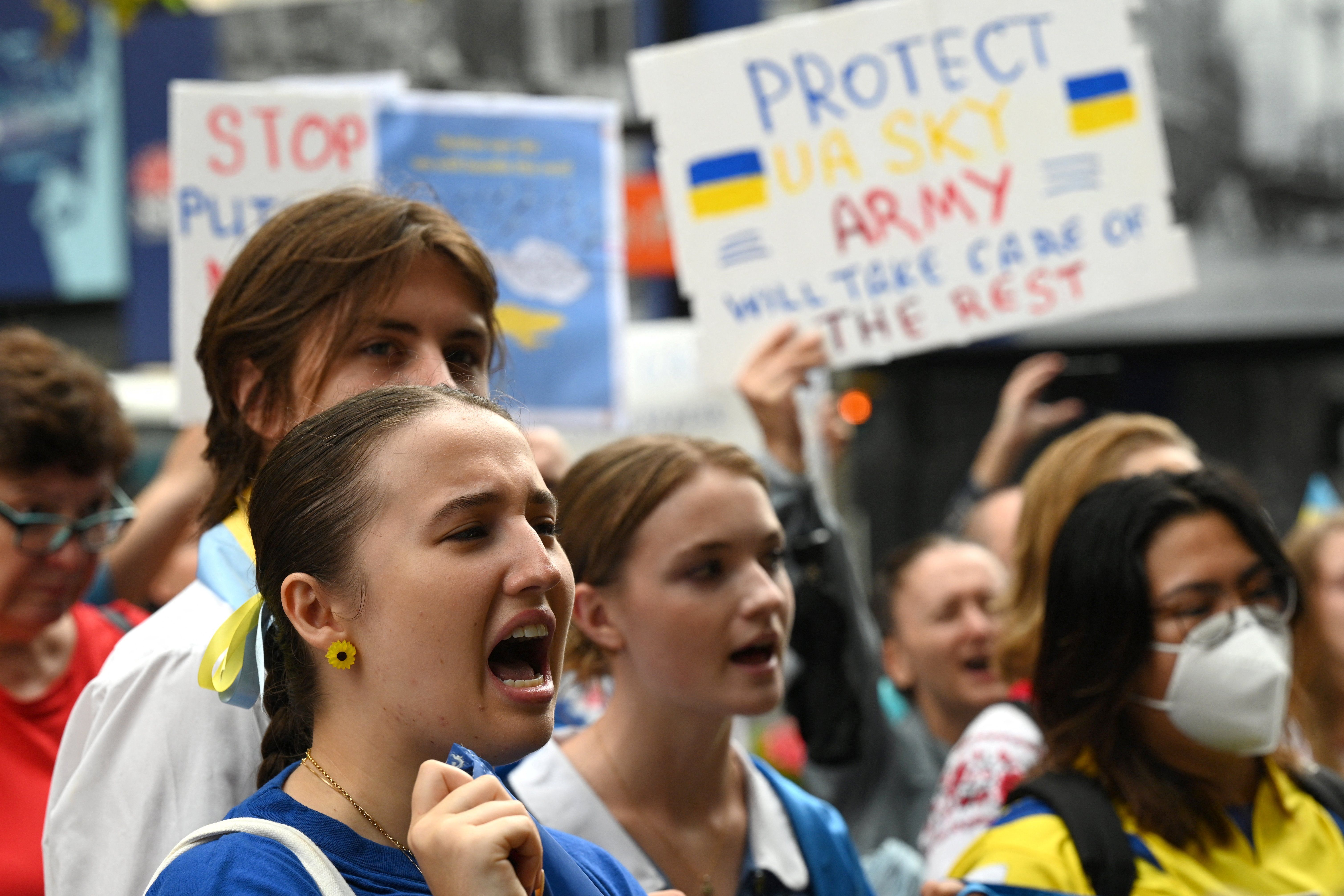 Protesters from Ukranian and Russian backgrounds shout slogans during a demonstration against the Russian invasion of Ukraine in Sydney on February 25