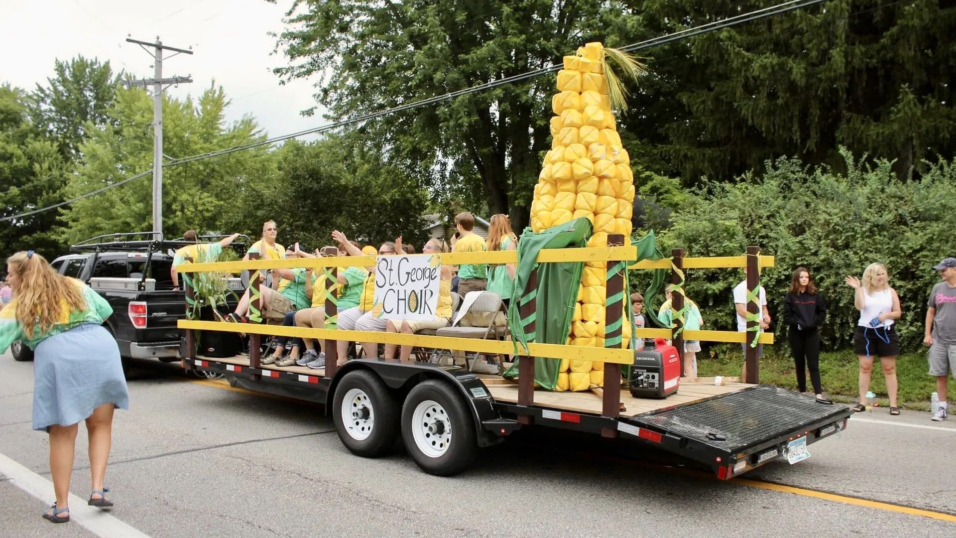 A photo of a parade float with giant ears of corn.