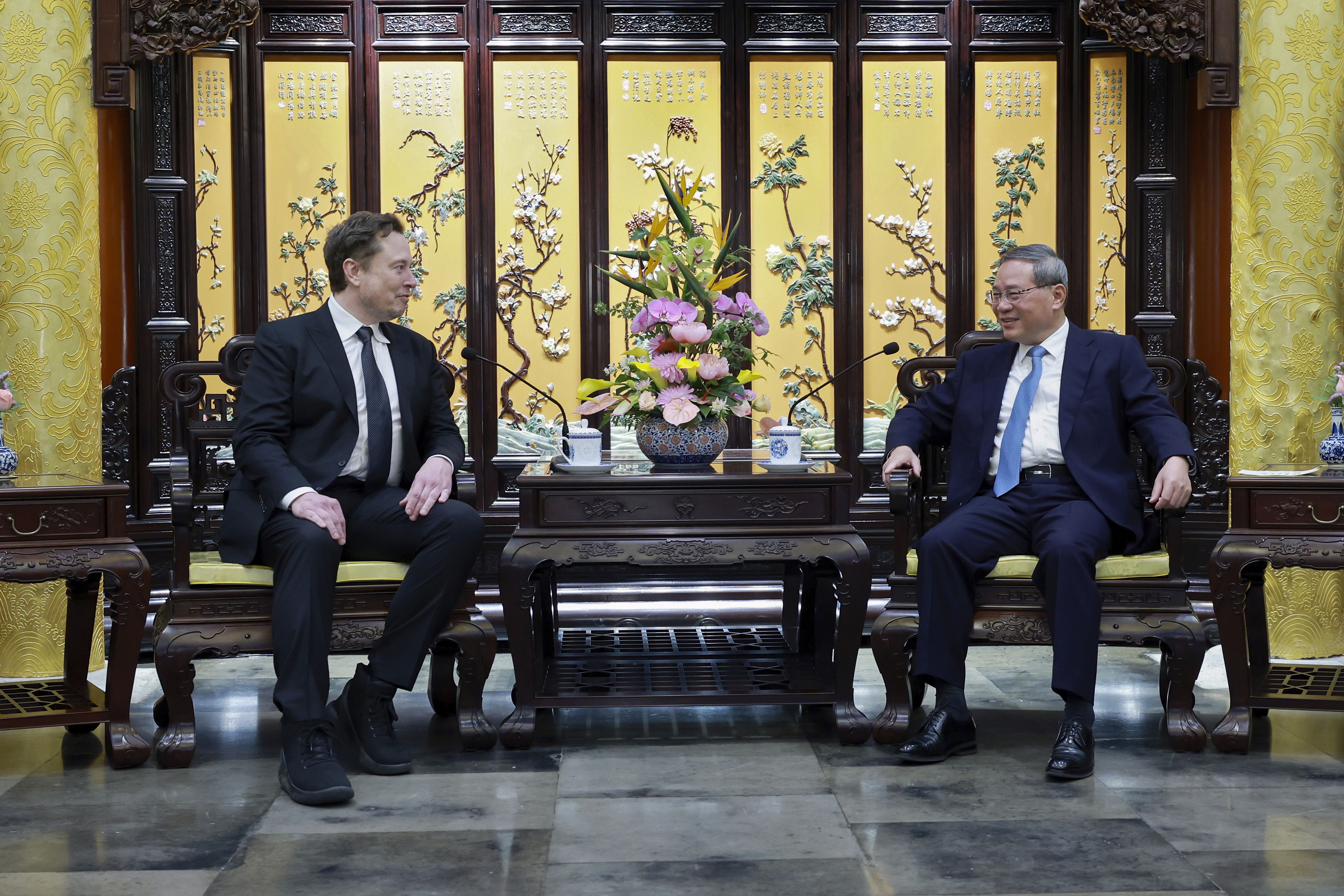 Elon Musk, left, meets with Chinese Premier Li Qiang in Beijing, Sunday, April 28, 2024. Musk met with a top government leader in the Chinese capital Sunday, just as the nation's carmakers are showing off their latest electric vehicle models at the Beijing auto show. 