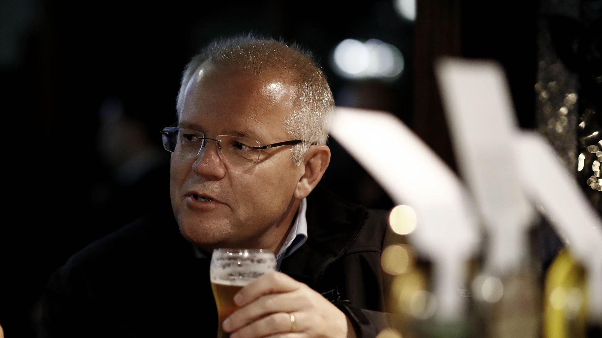 Australia's PM Scott Morrison drinks a beer while campaigning in the Australian federal election.