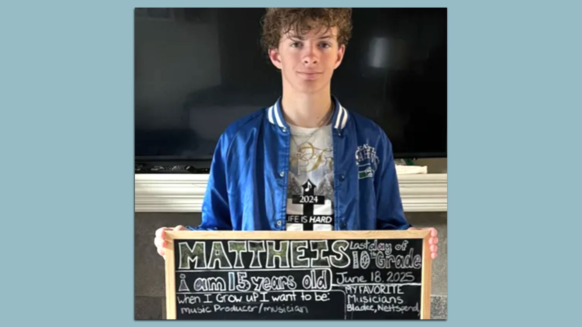 Teen boy with curly hair in a blue jacket holding a chalkboard with details: name Mattheis, 15 years old, last day of 10th grade June 18, 2025, wants to be a music producer/musician.
