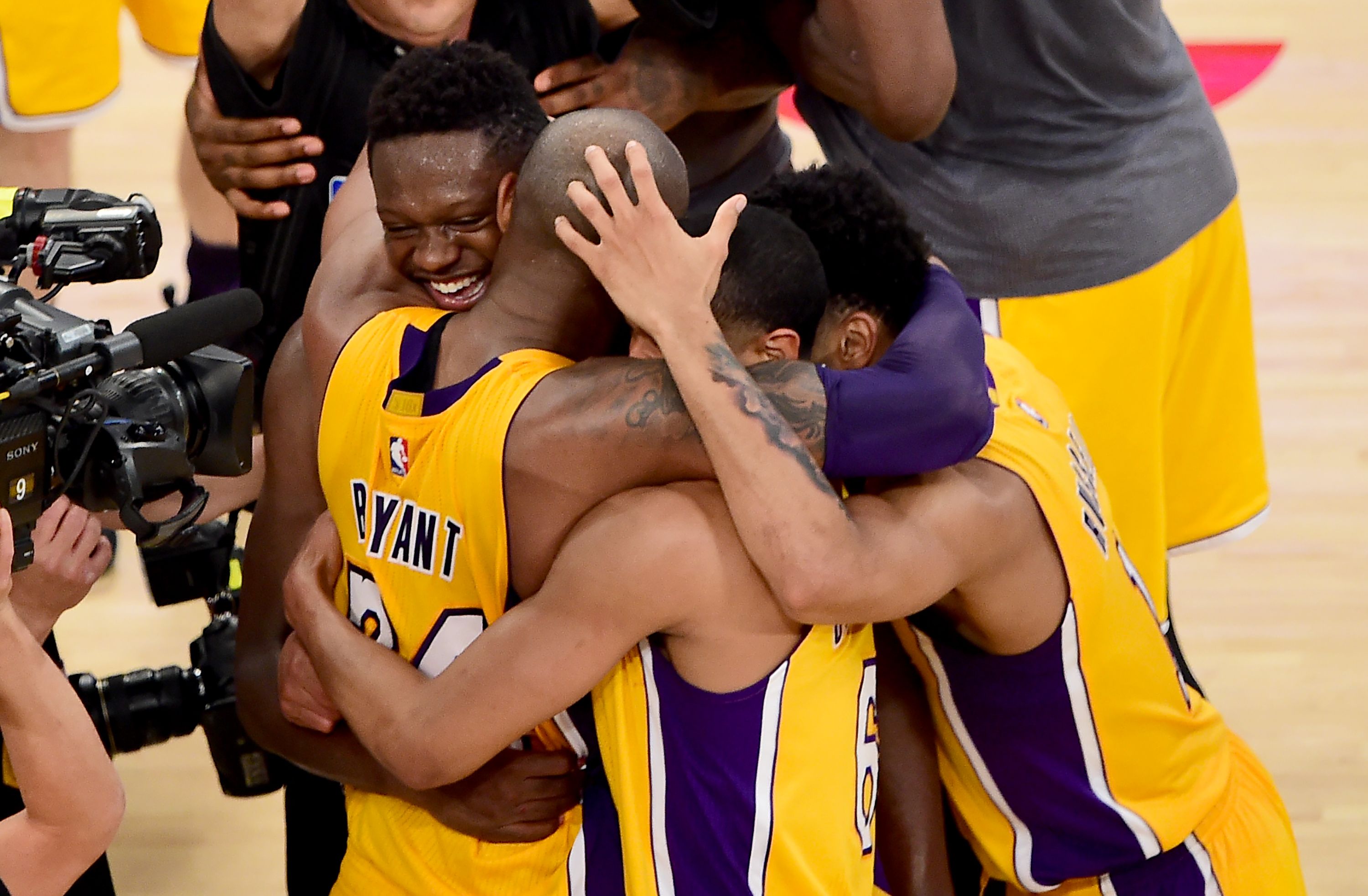 Kobe Bryant of the Los Angeles Lakers celebrates with teammates following his final game as a Laker